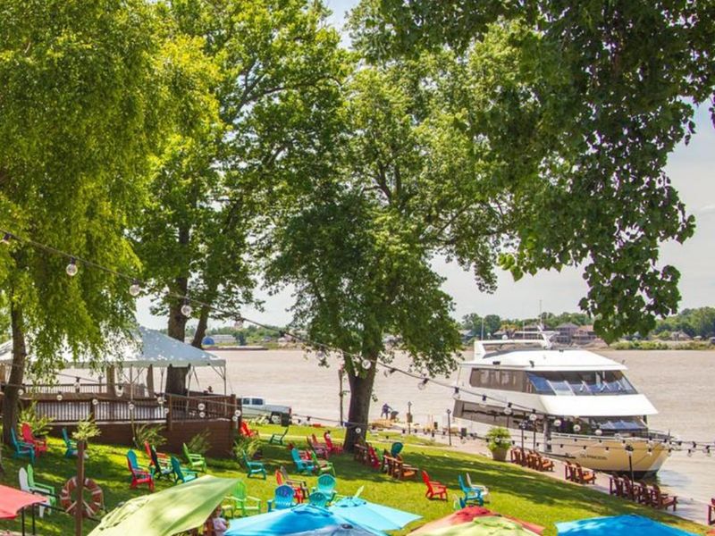 Tiered riverside decks with colorful umbrellas on the Ohio River