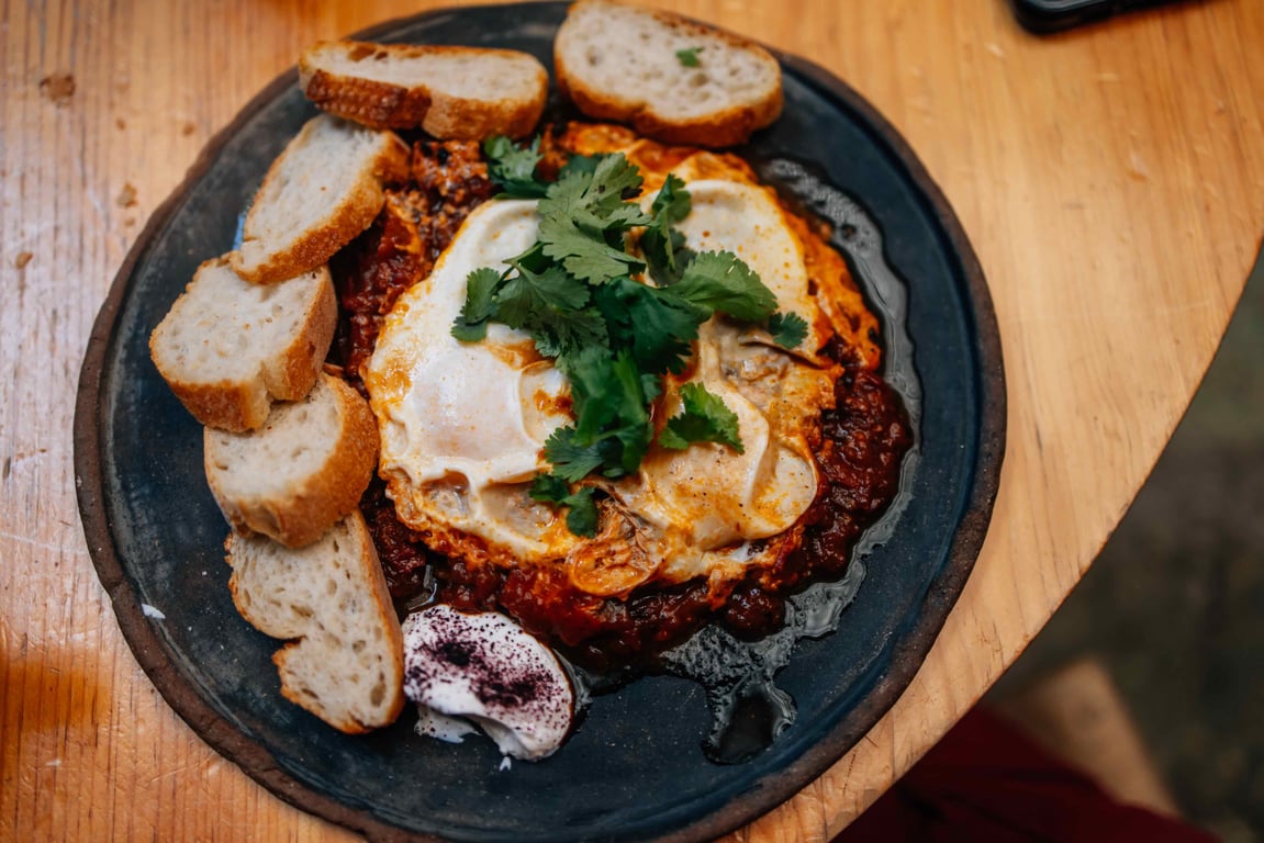 Savory baked dish served with sliced bread
