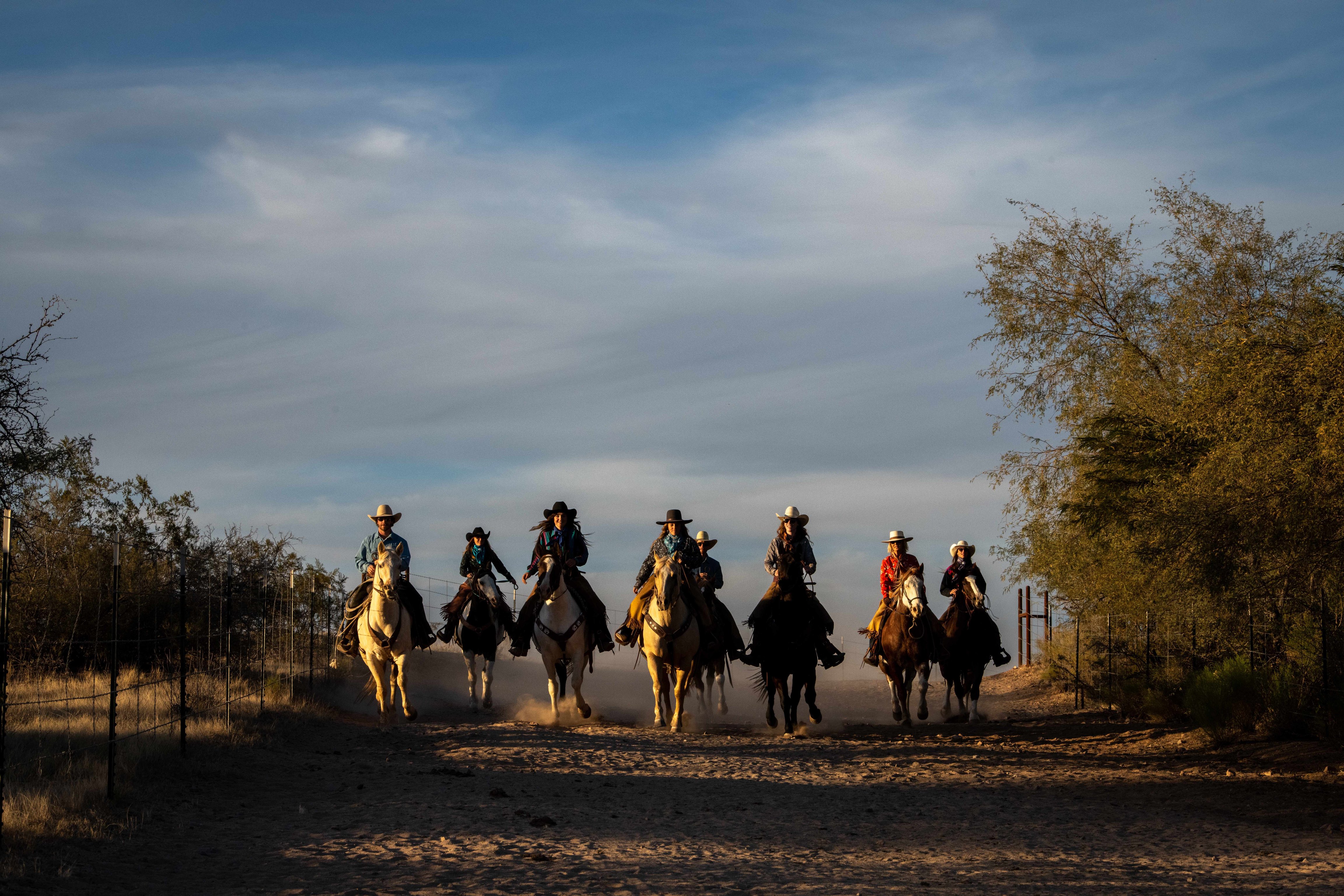 Horseback riders crossing a desert trail at Rancho de los Caballeros