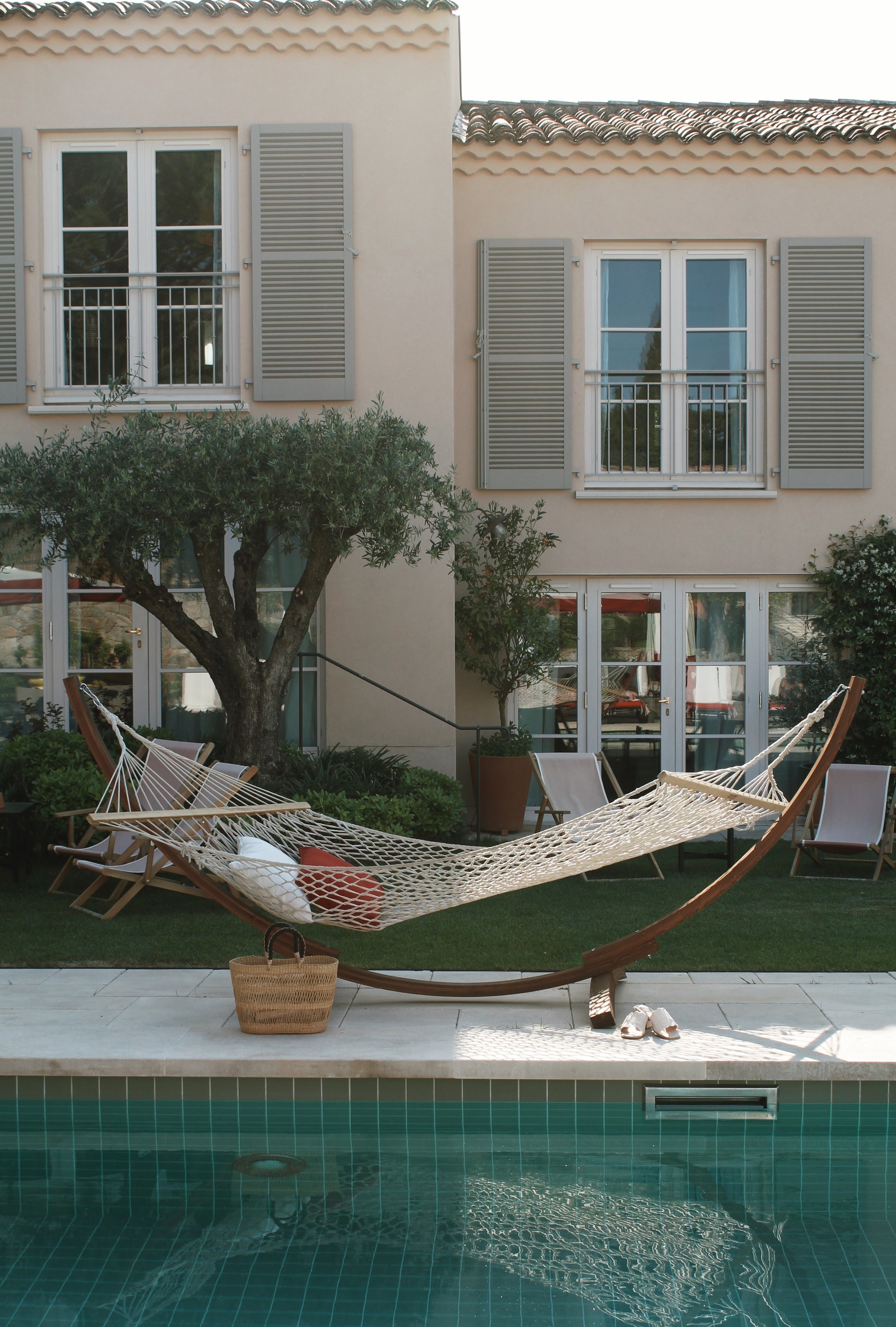 Hammock beside the pool and shuttered villa at Hôtel Lou Pinet
