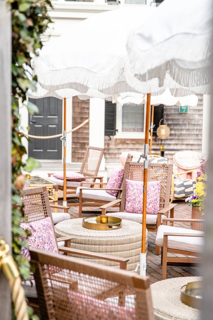 Outdoor dining tables beneath white umbrellas at Faraway Nantucket