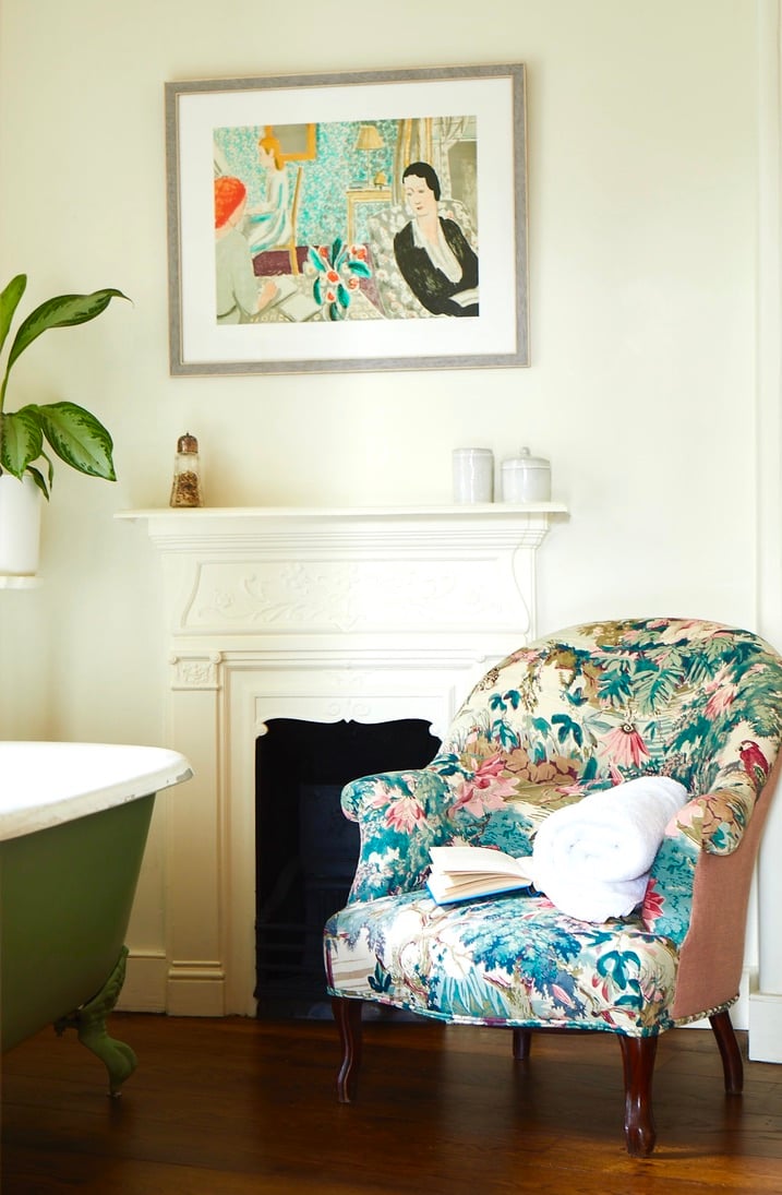 Floral armchair beside a fireplace at Number One Bruton