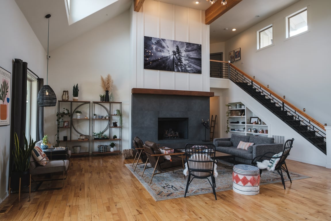 Modern barnhouse lounge with a staircase and game table