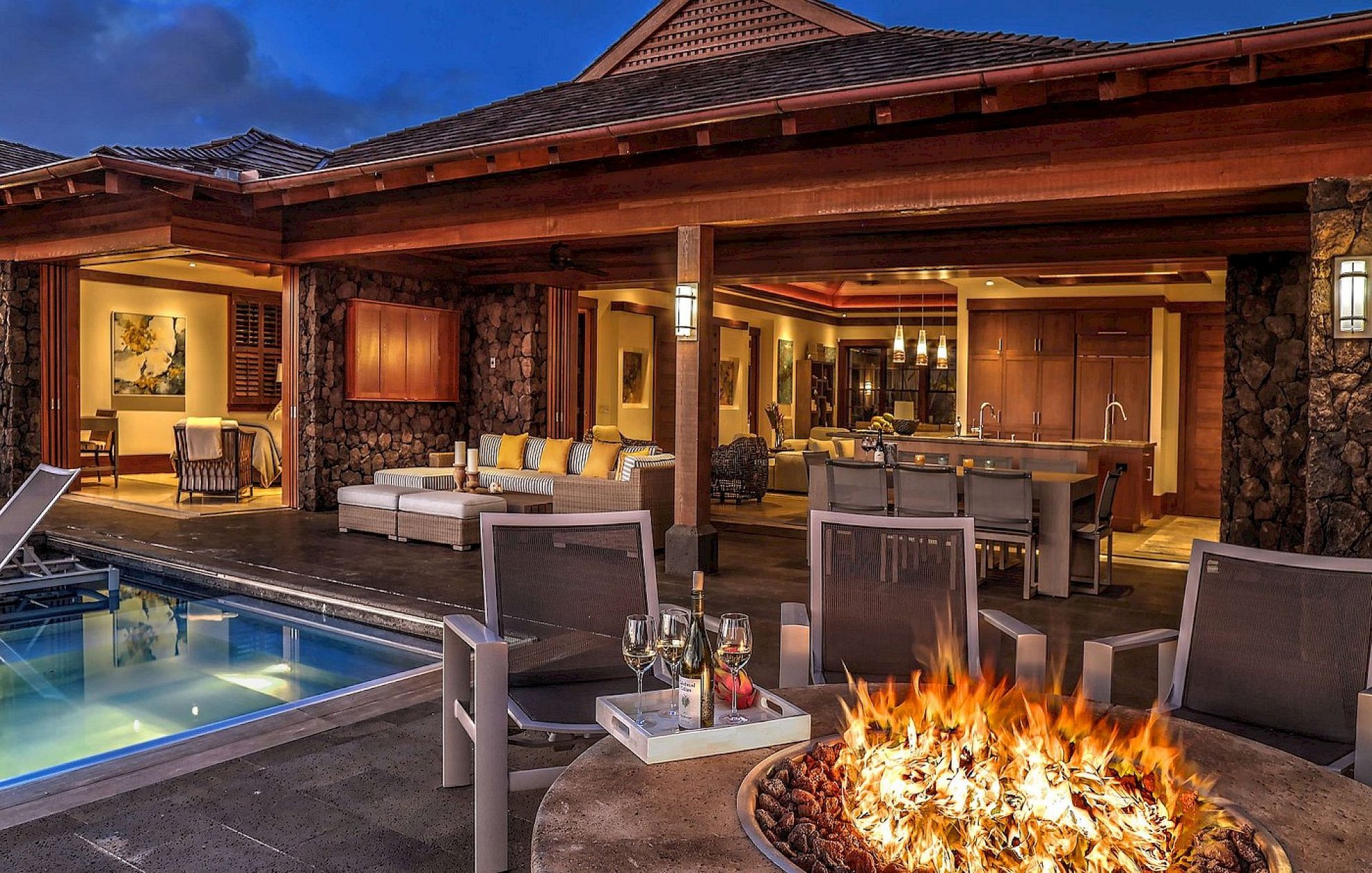 Poolside fire pit and open-air clubhouse at The Lodge at Kukuiʻula