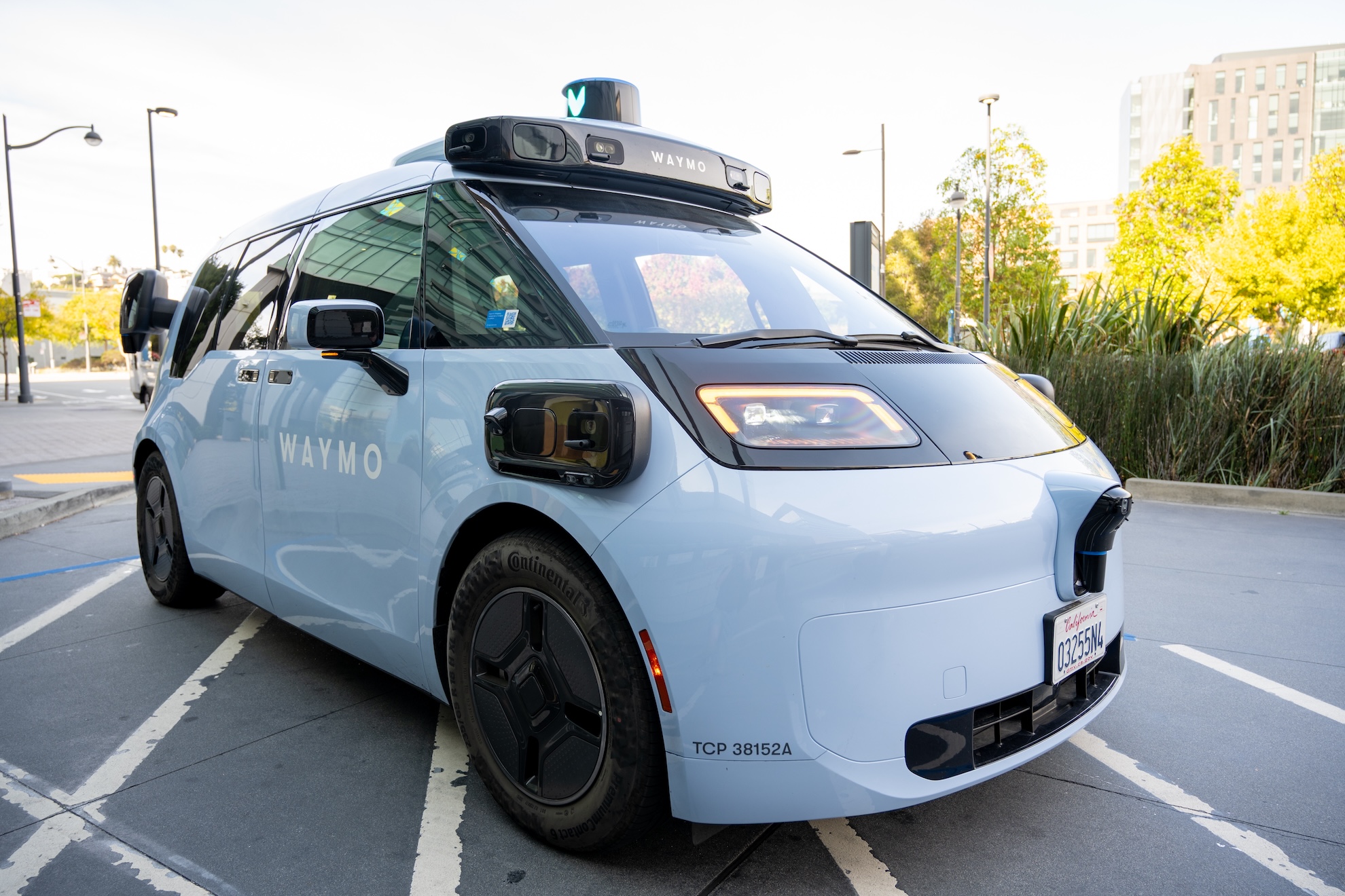 An autonomous vehicle operating on a road with sensor equipment on its roof.