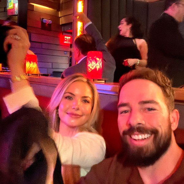 Adam and a friend smiling for a selfie on a night out