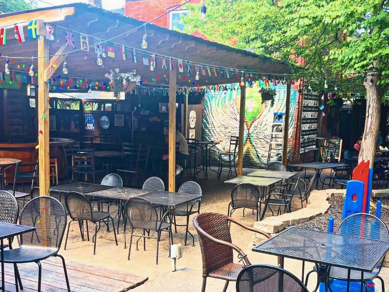 Shaded beer garden with flags and string lights at Flanagan's Ale House