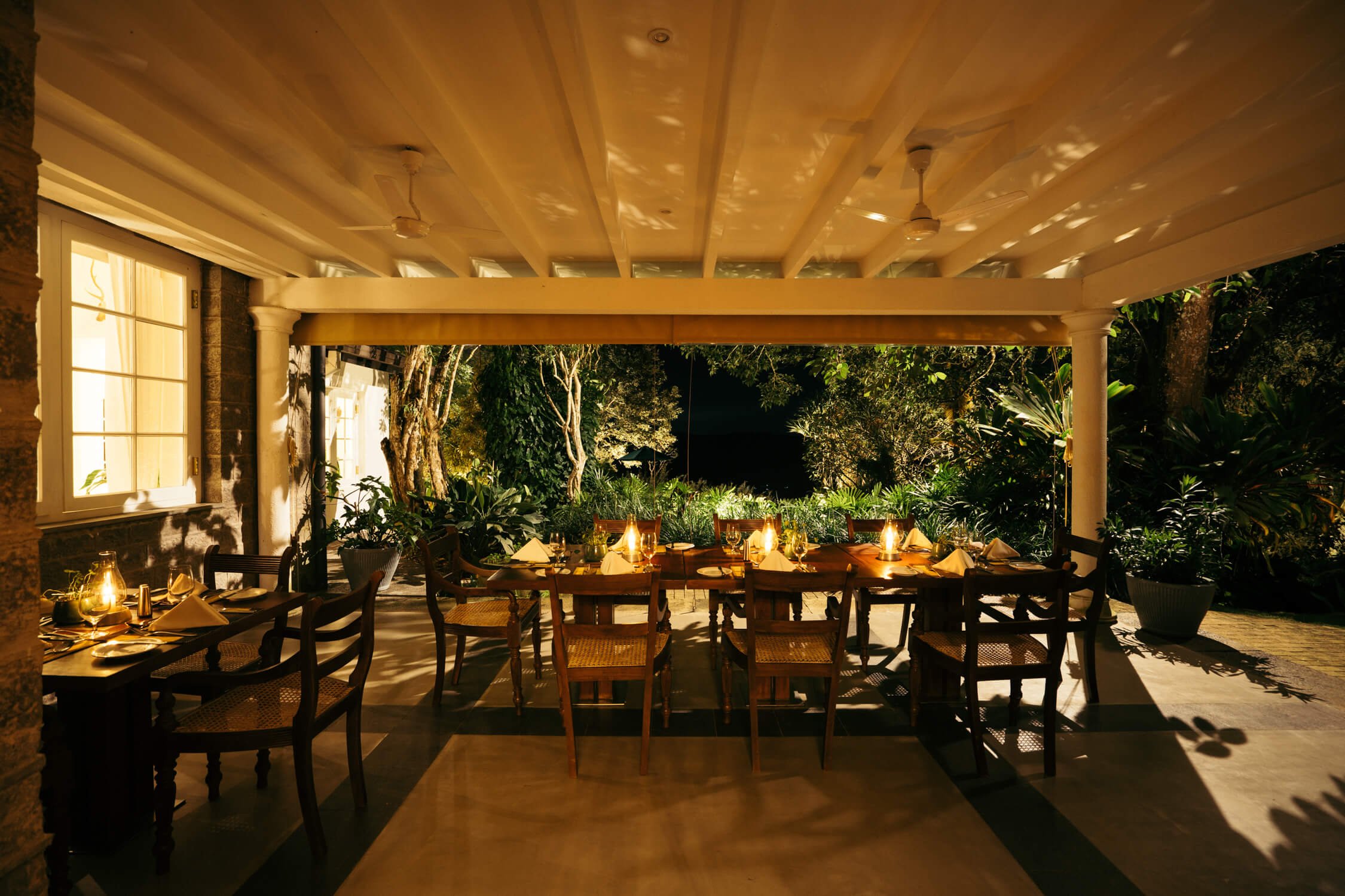 Open-air dining terrace at Glenross Living in the evening
