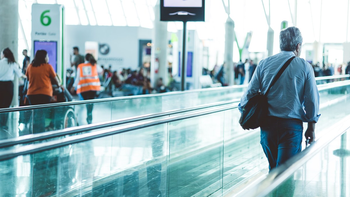 Airport security checkpoint with passengers in line