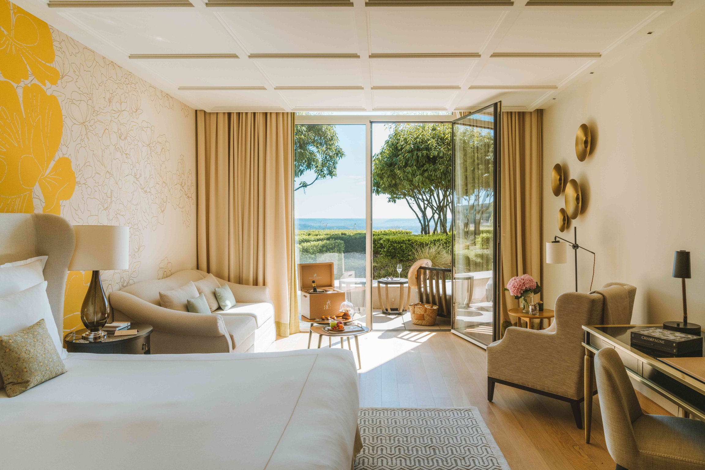 Sunlit guest room at Royal Champagne Hotel + Spa with vineyard views