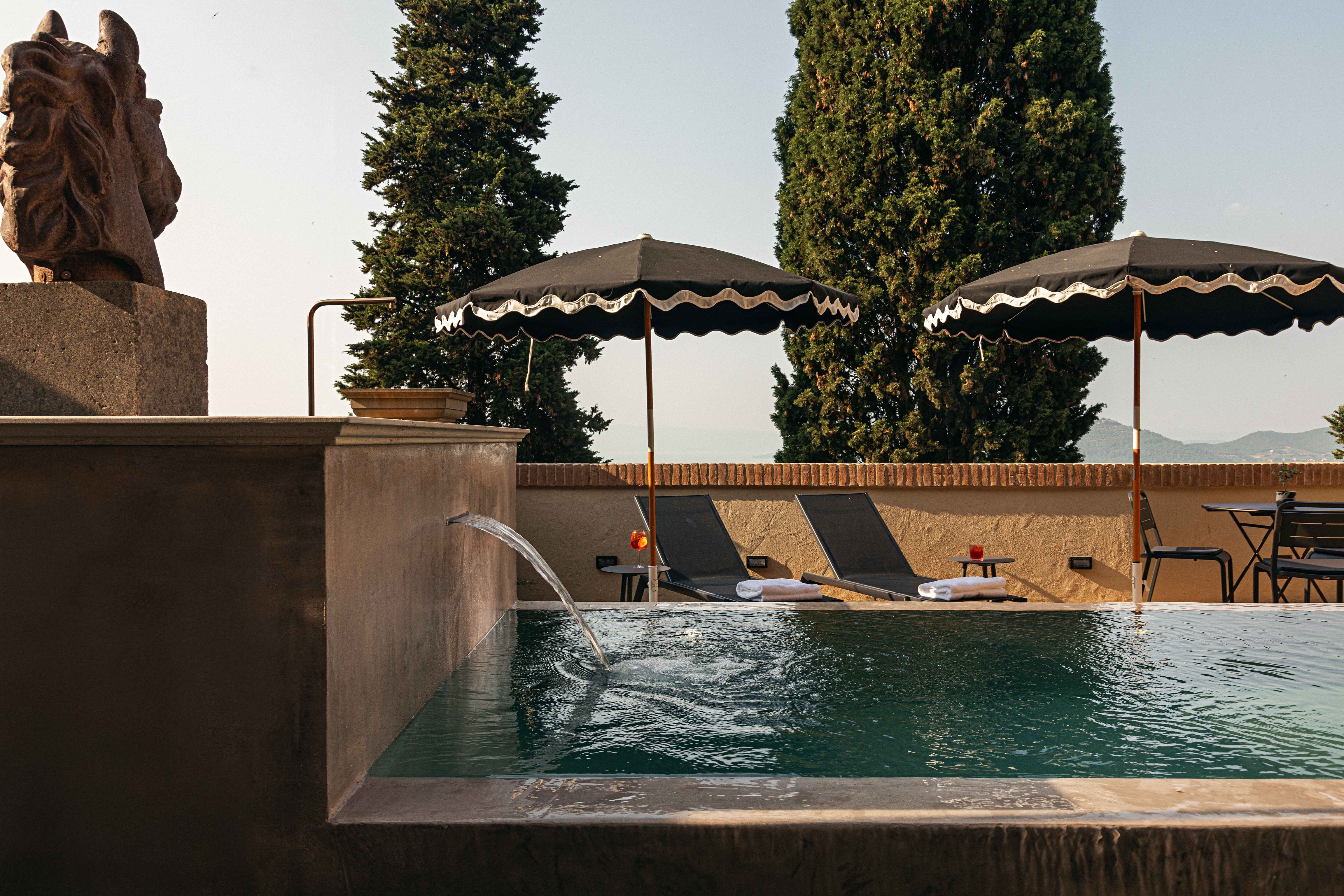 Outdoor plunge pool and umbrellas at Rastrello
