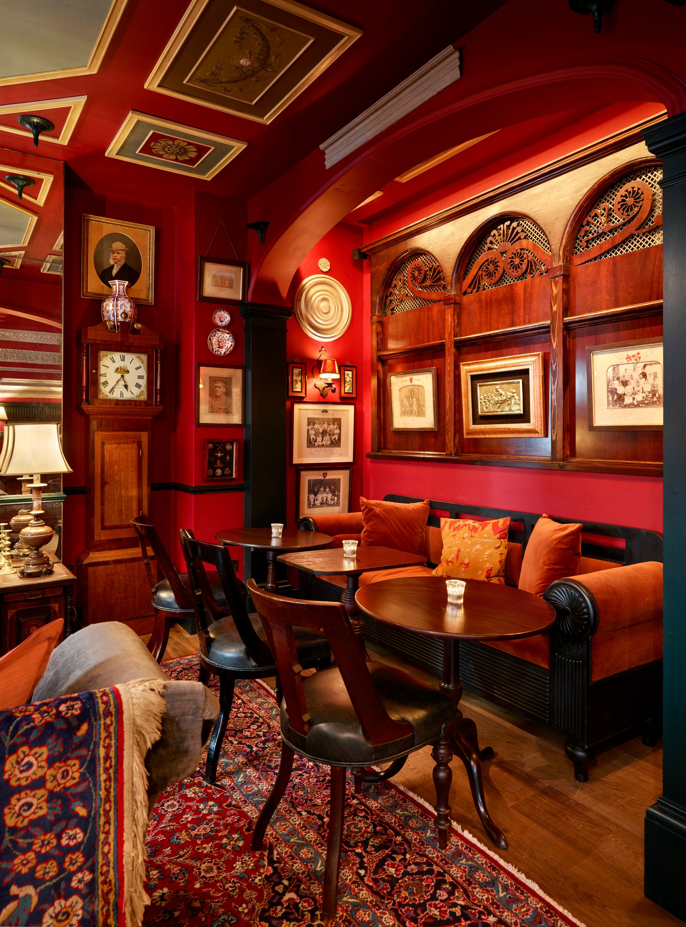 Rich red walls and framed artwork in The Zetter Marylebone’s Parlour