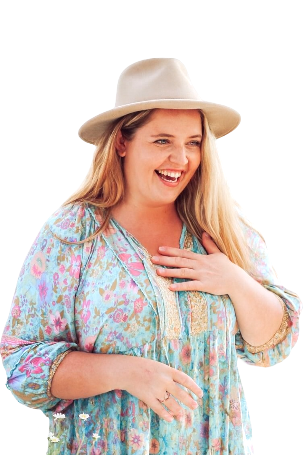 Karlee Hayes laughing, wearing a cream hat and floral dress