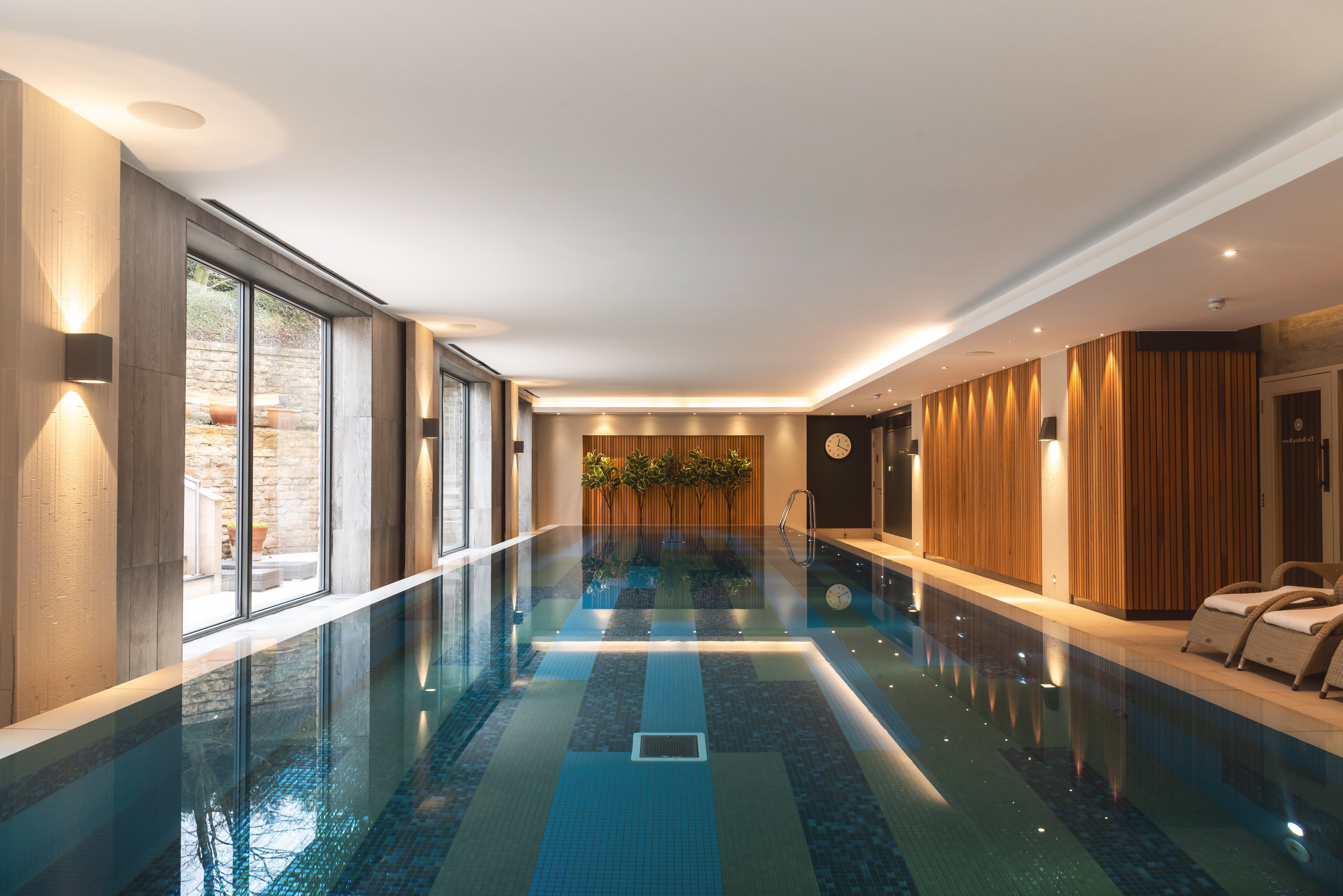 Indoor spa pool beside tall windows at Dormy House