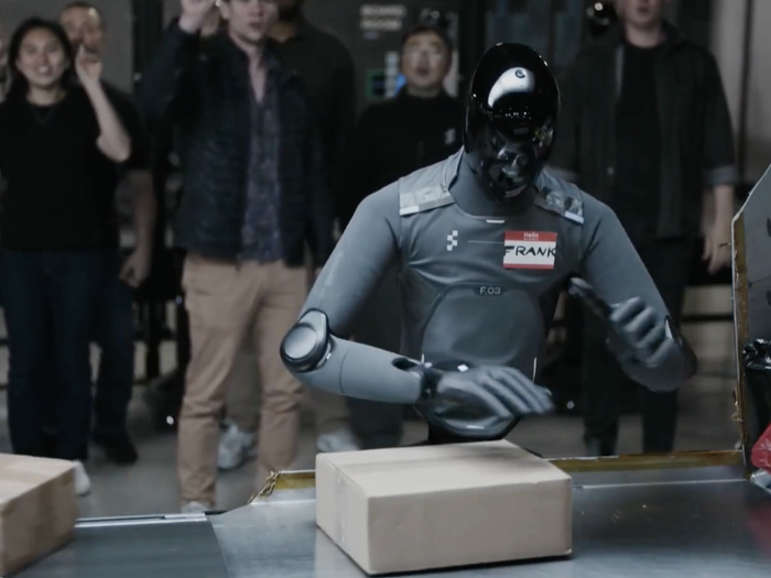 Humanoid robot sorting packages in a warehouse