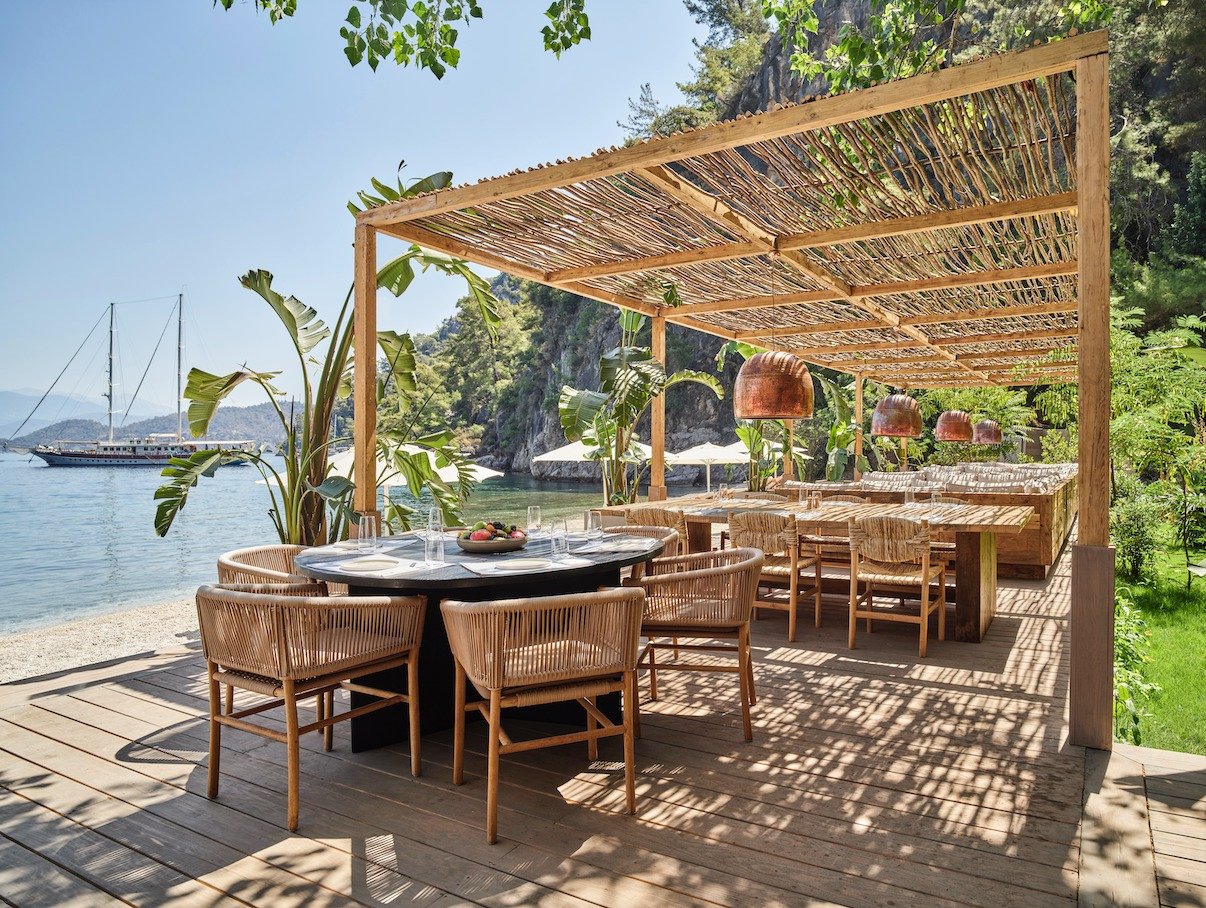Seaside dining under a pergola at Yazz Collective