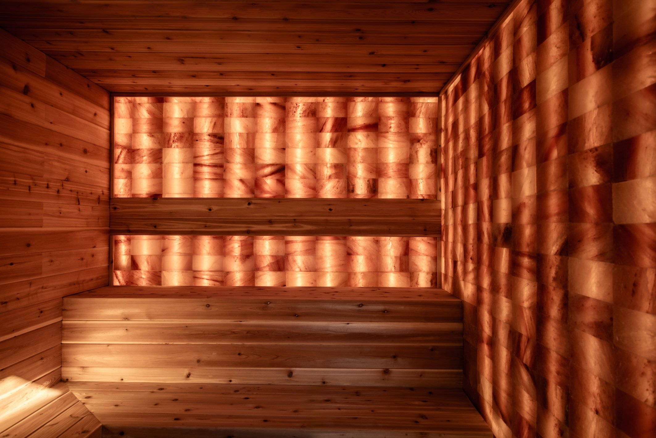 Wood-lined sauna with illuminated salt panels at Terra Palm Springs
