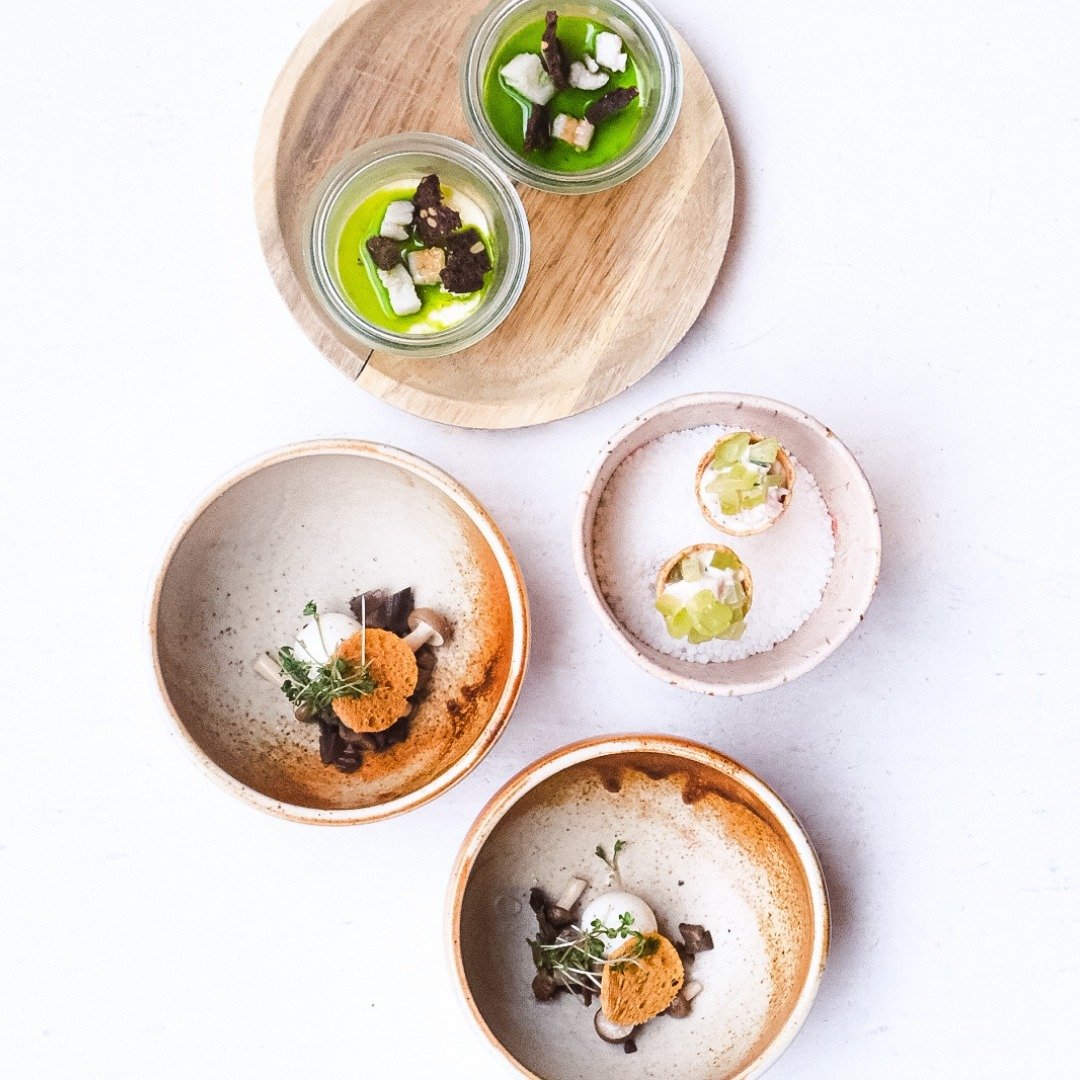 Overhead arrangement of five colorful plated dishes