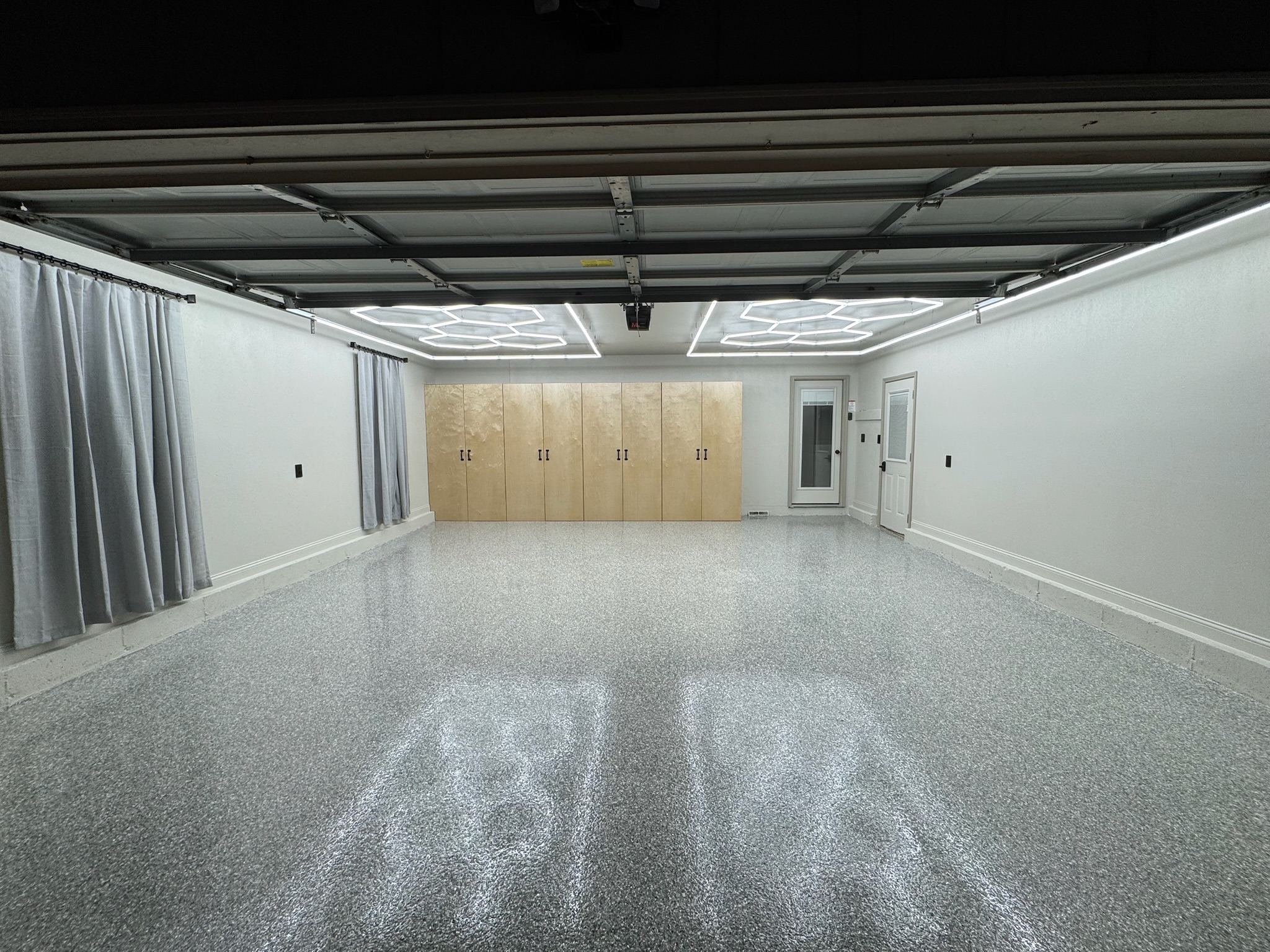 Finished garage renovation with hexagon lighting