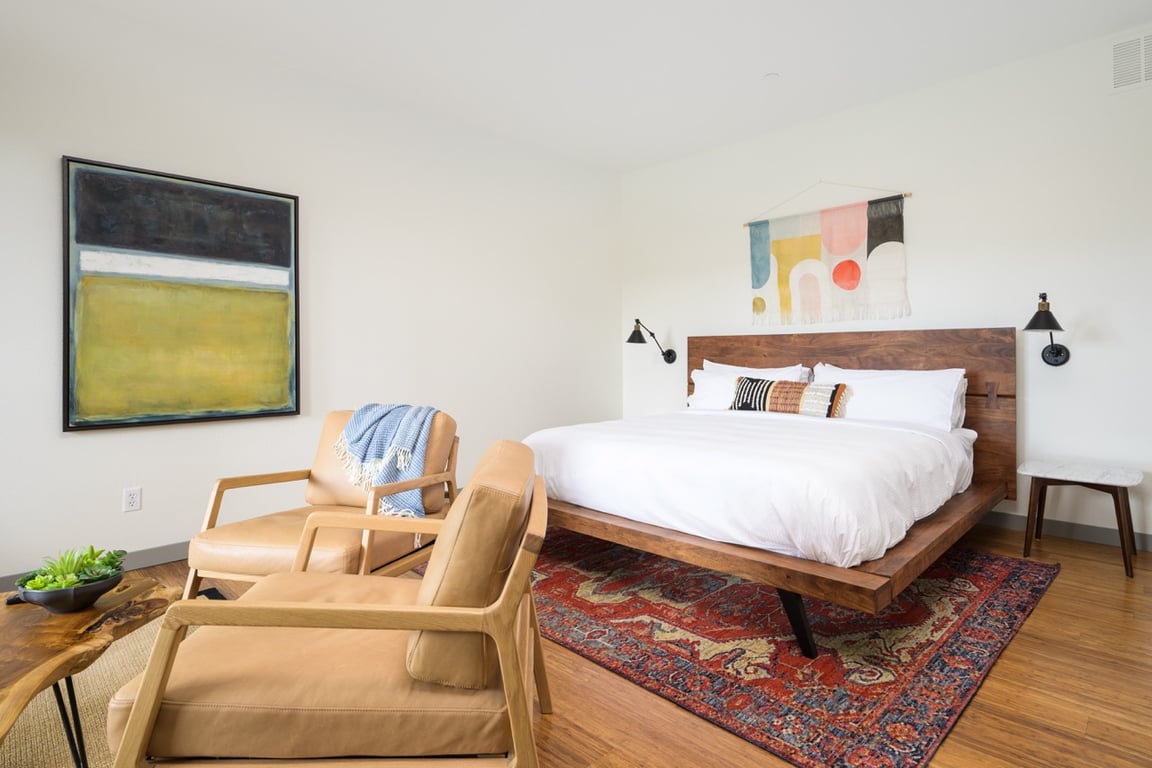Guest bedroom with neutral furnishings and garden light