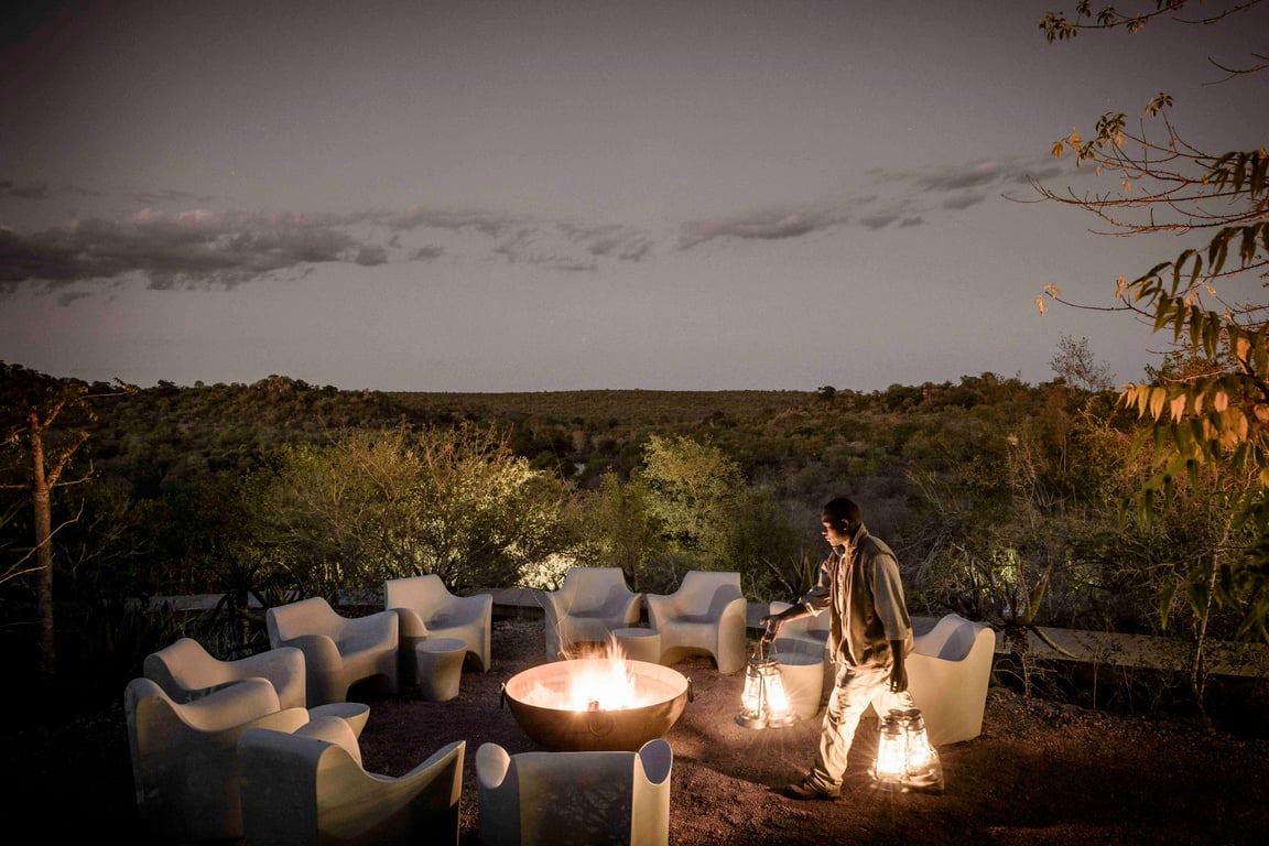 Outdoor lounge around a fire at Singita Lebombo
