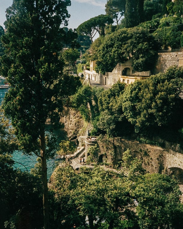 Historic Portofino buildings and garden paths cascading toward the sea