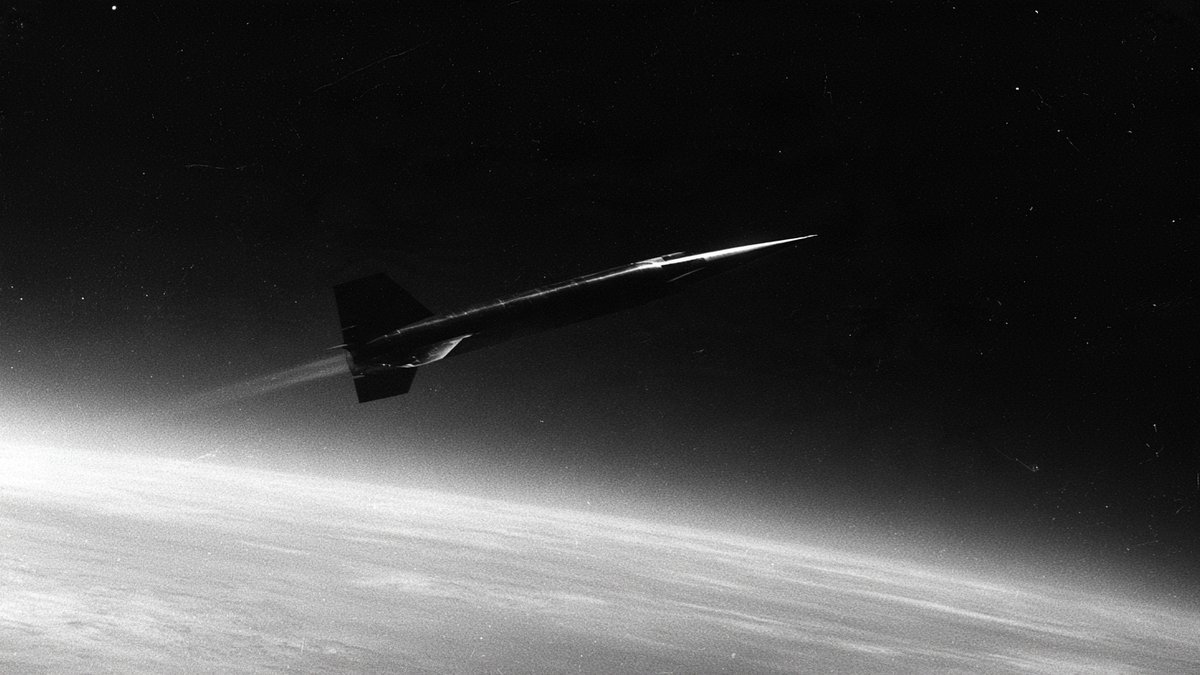 The X-15 rocket plane in flight above Earth