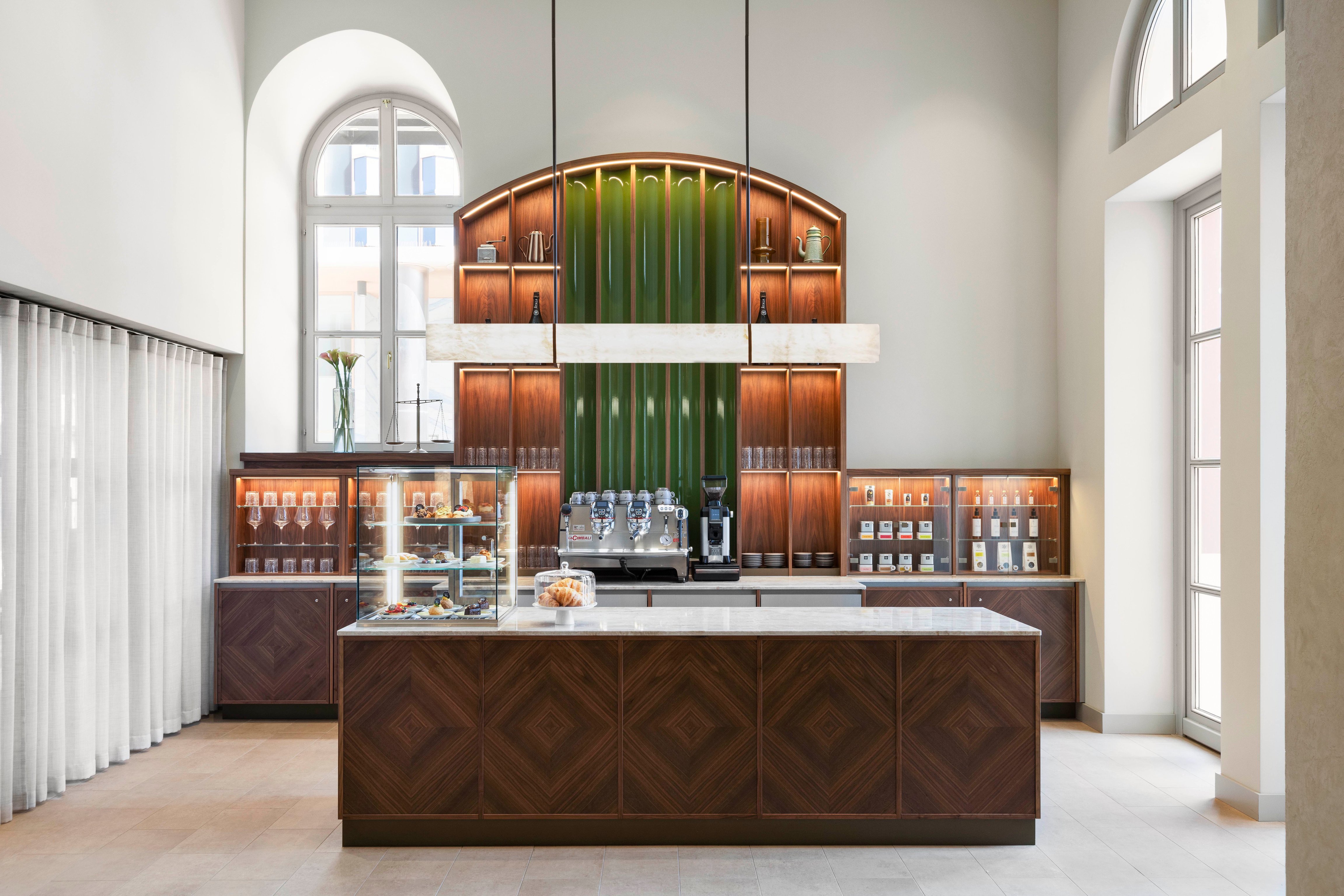 Coffee counter beneath a tall arched window at the Imperial Riding School