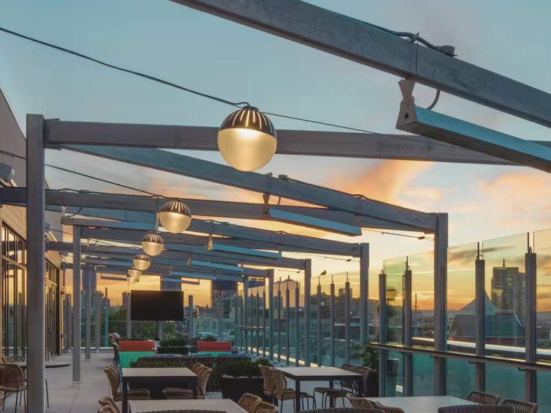 Covered rooftop lounge at sunset at High Stakes Rooftop
