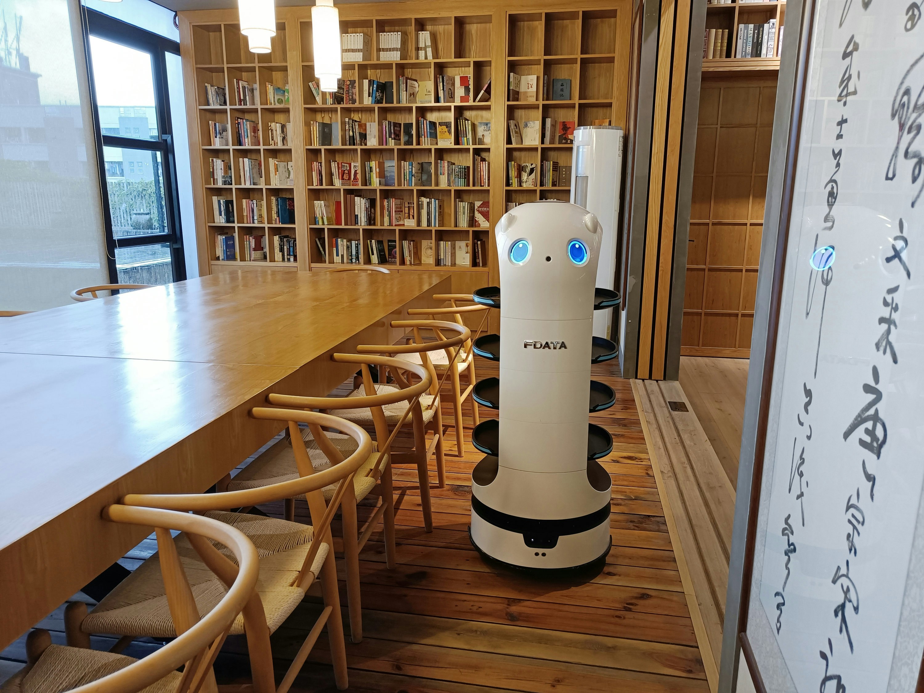 An autonomous service robot operating in a public indoor space, highlighting the expansion of Physical AI into everyday life.