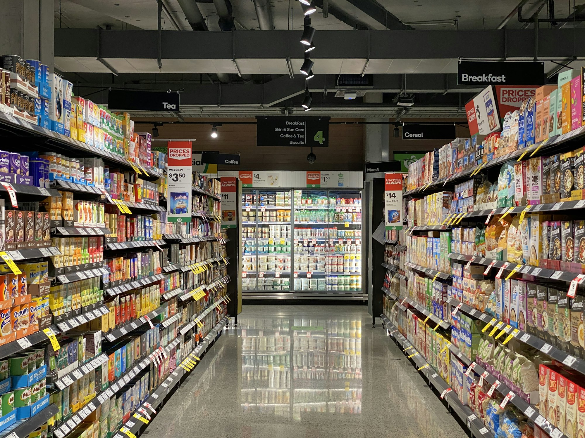 Grocery store aisle with fully stocked shelves