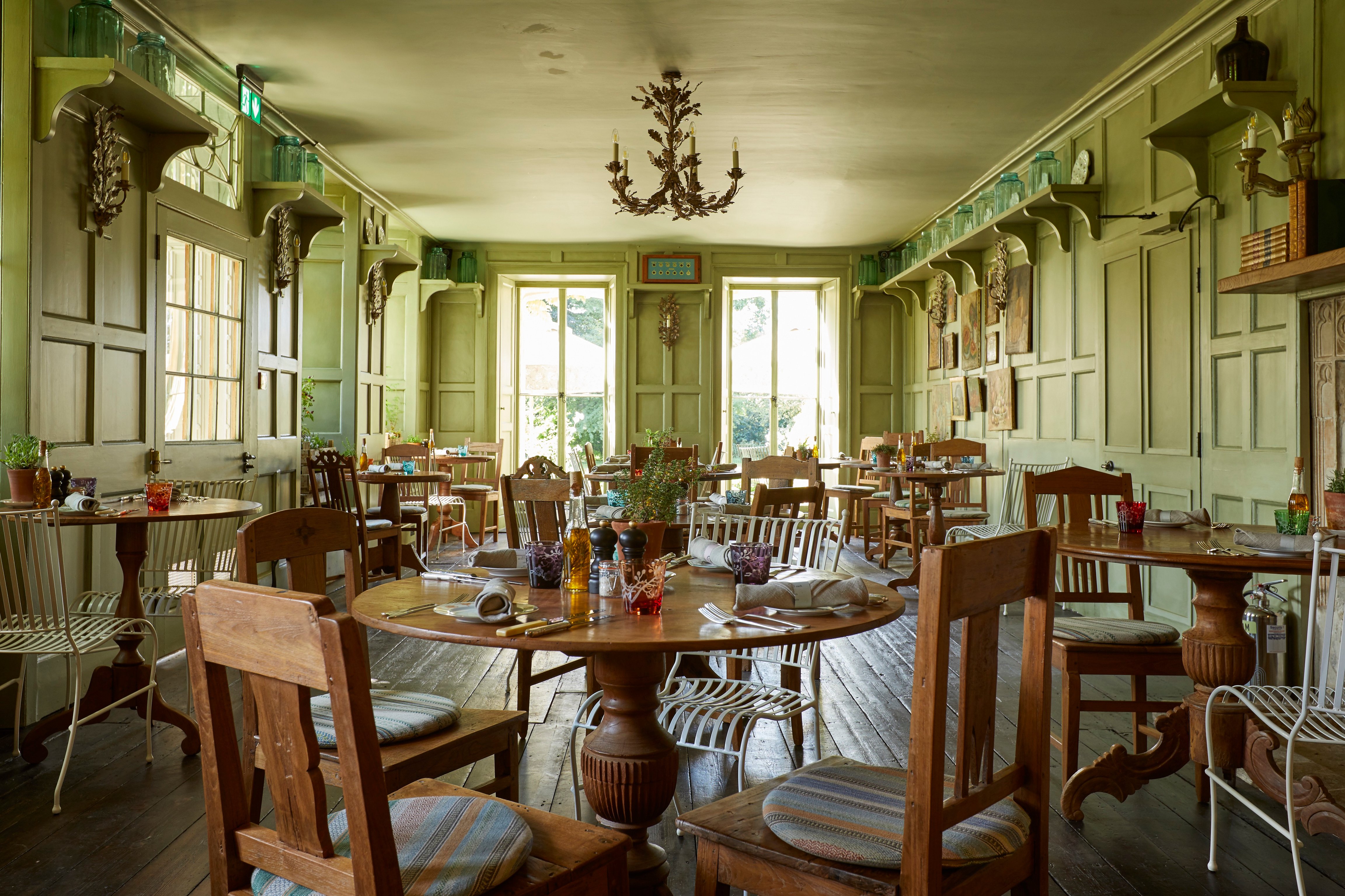 Green dining room set for service at The Pig