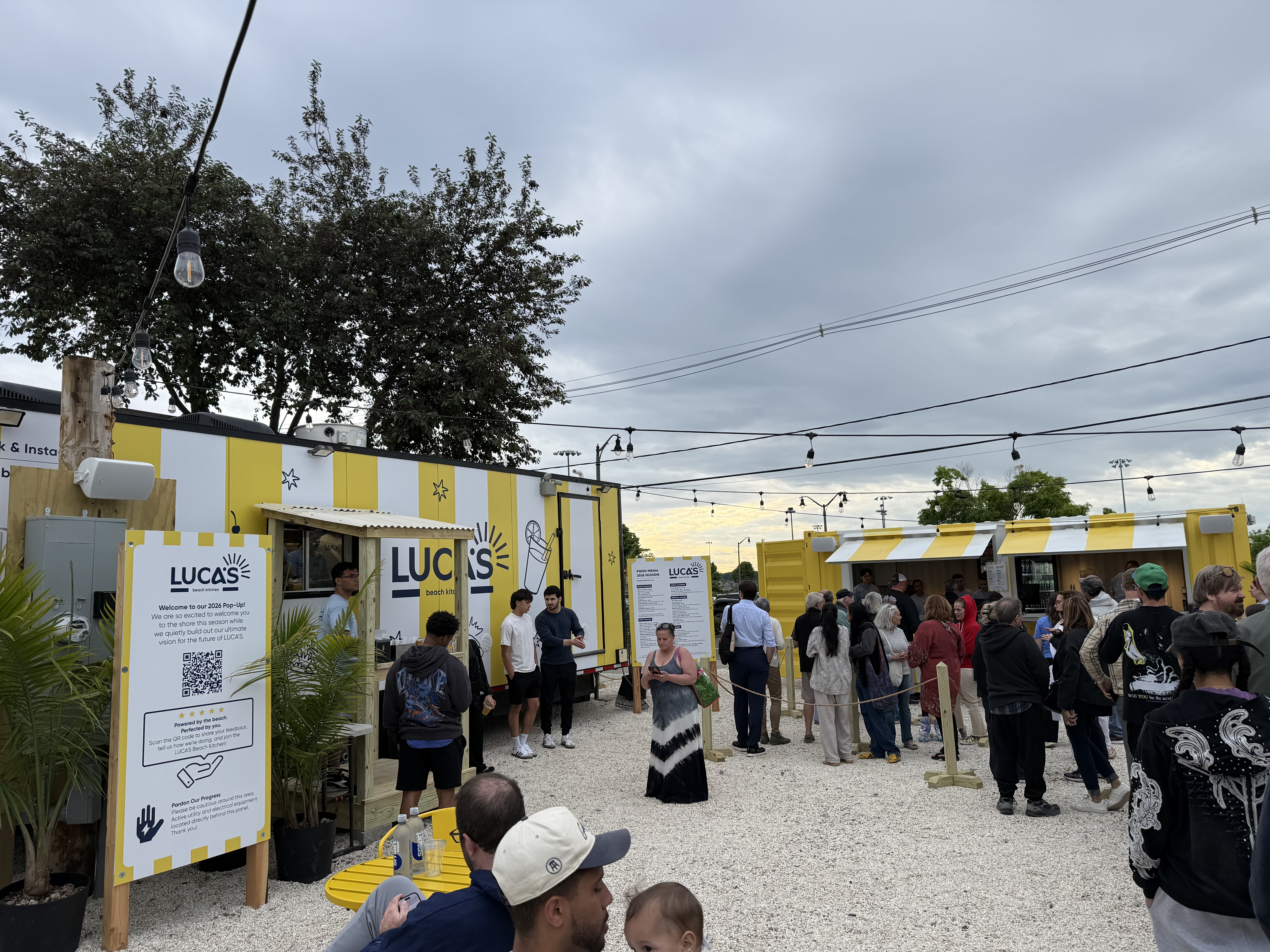 Opening night crowd at Luca's Beach Kitchen, the new yellow-and-white striped trailer concession at Calf Pasture Beach in Norwalk.
