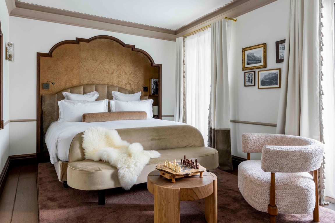 Guest bedroom with a sculpted upholstered headboard