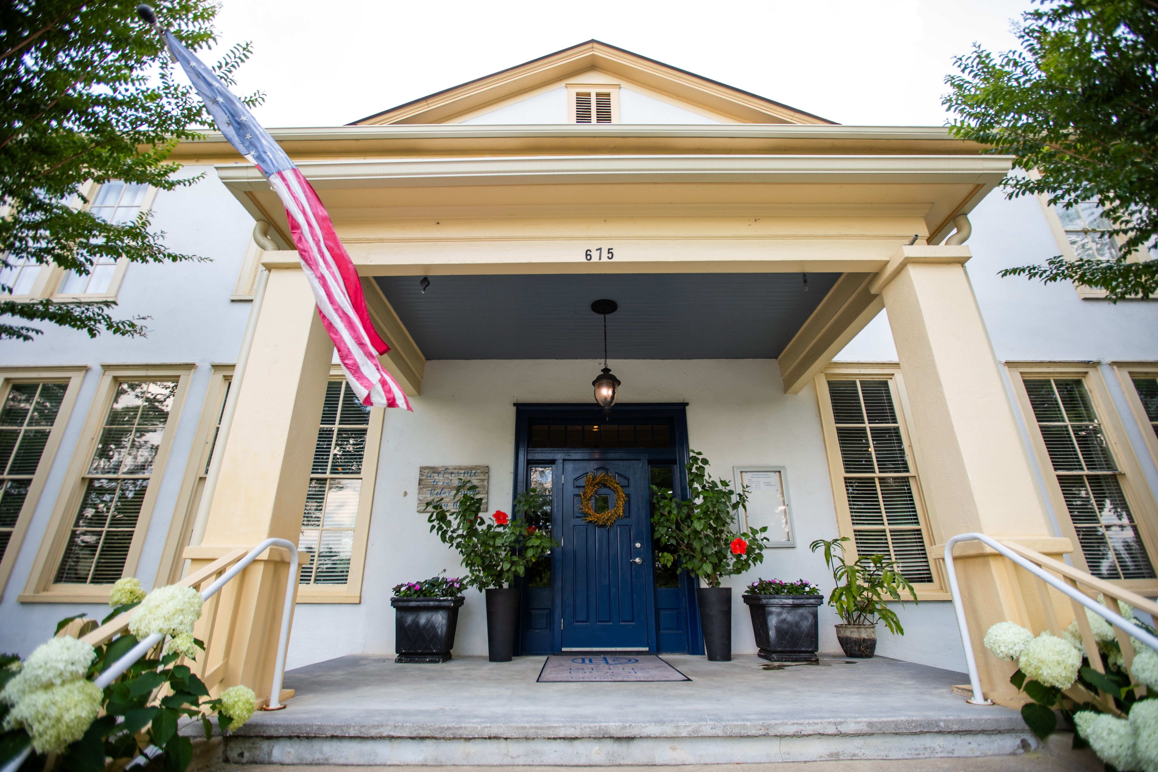 Front porch and blue entrance door at The Blue Door Inn