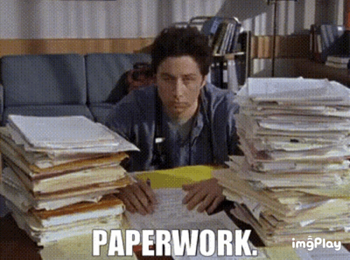 A man buried in stacks of paperwork