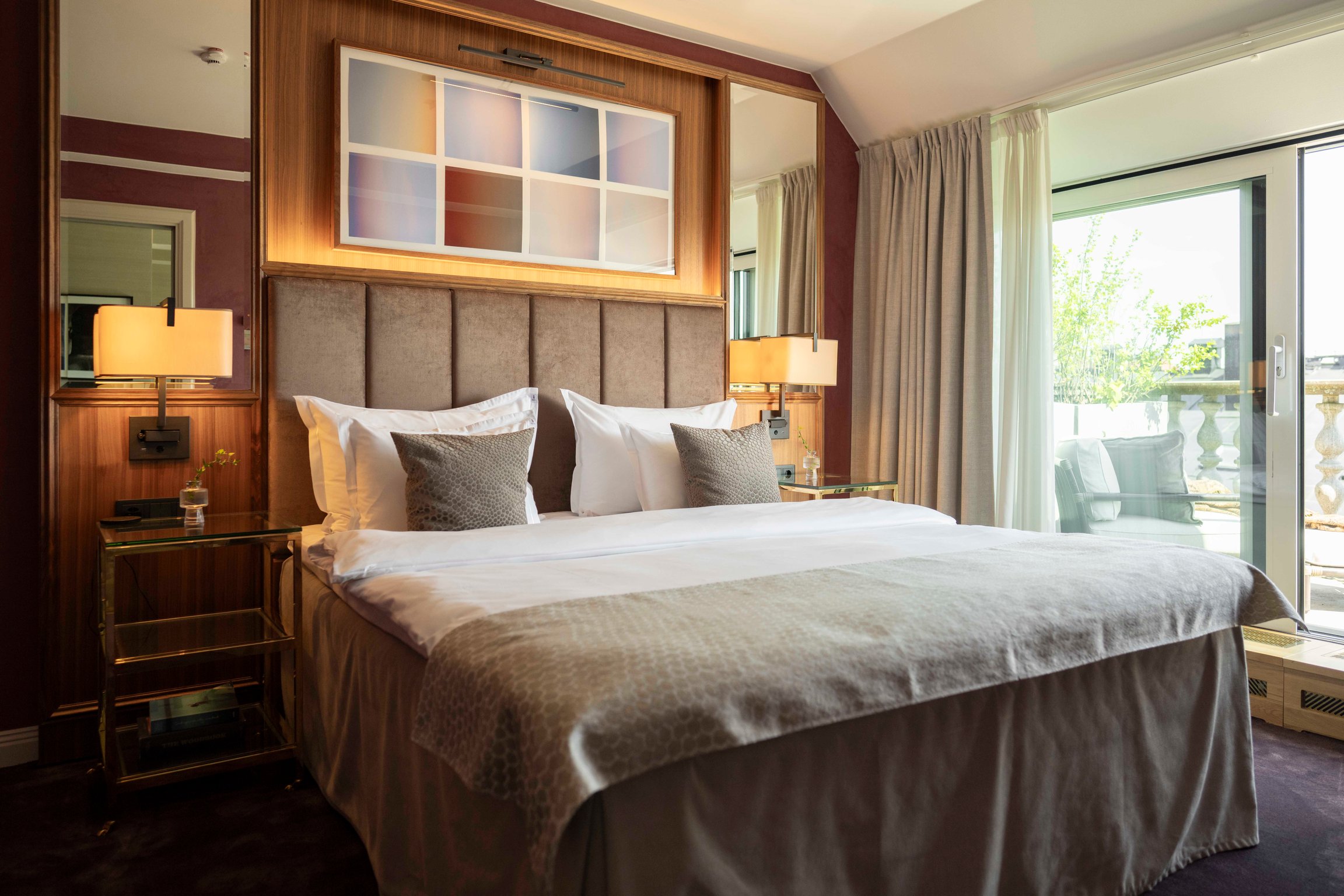Guest bedroom with plush upholstery and colorful artwork