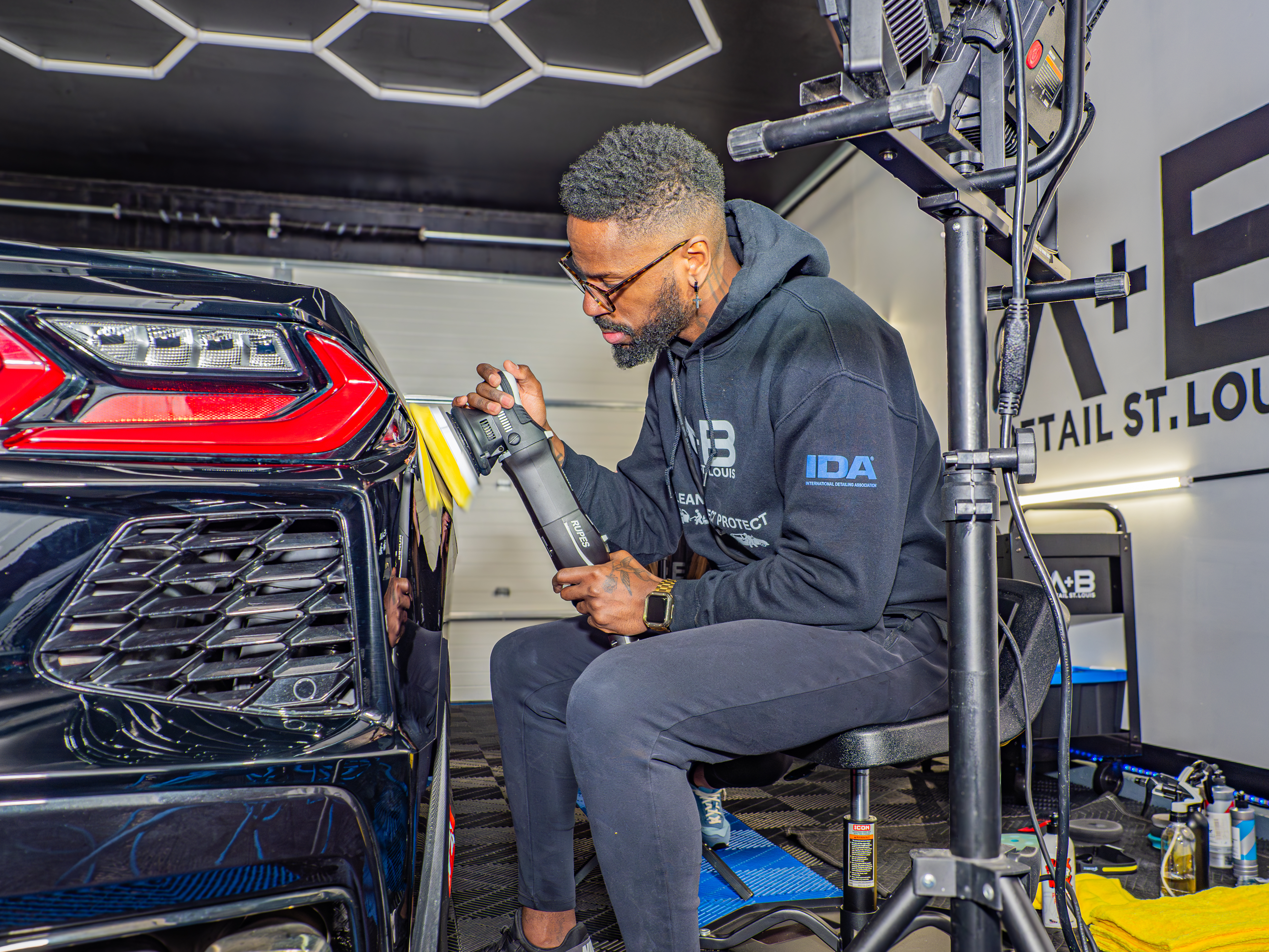 Anthony Meyer carefully polishing the front of a vehicle