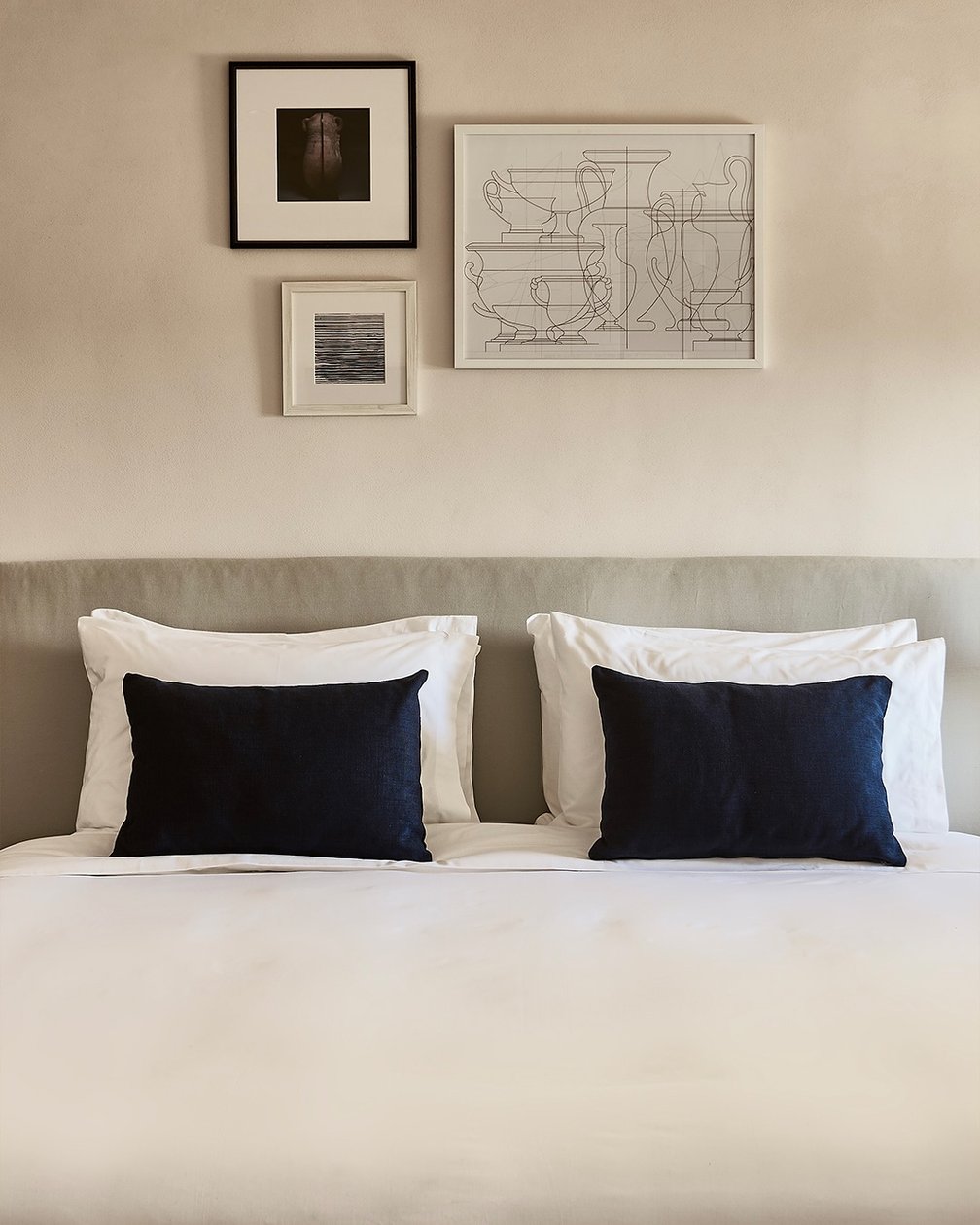 Istoria guest room with white linens and black accent pillows