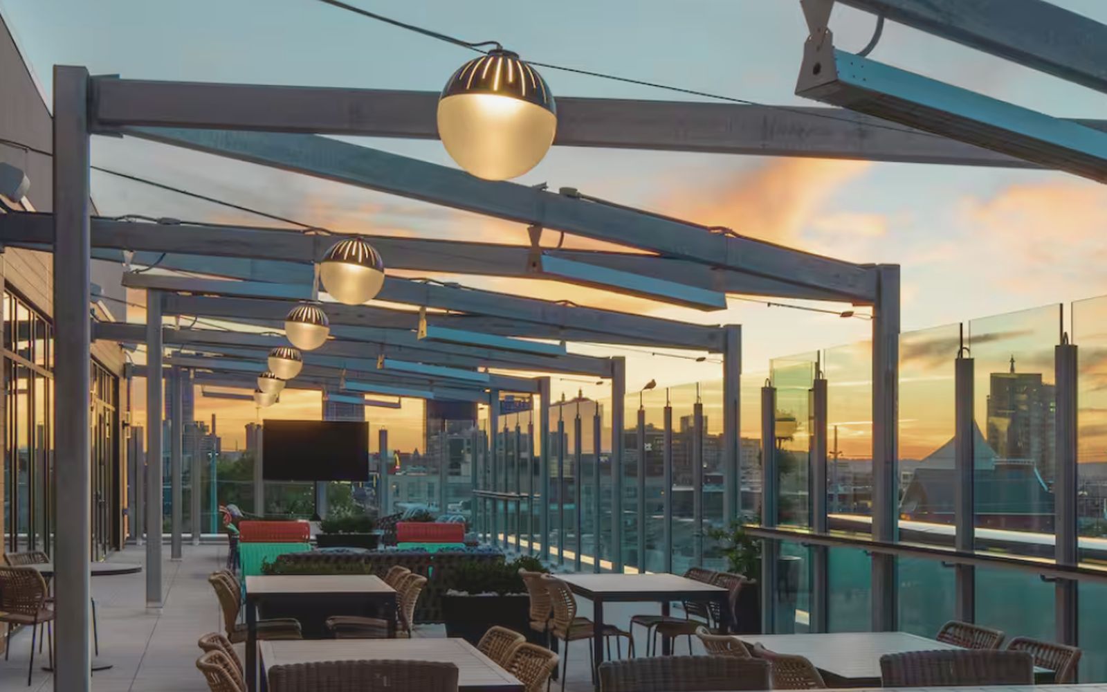 Rooftop patio at sunset overlooking the Louisville skyline