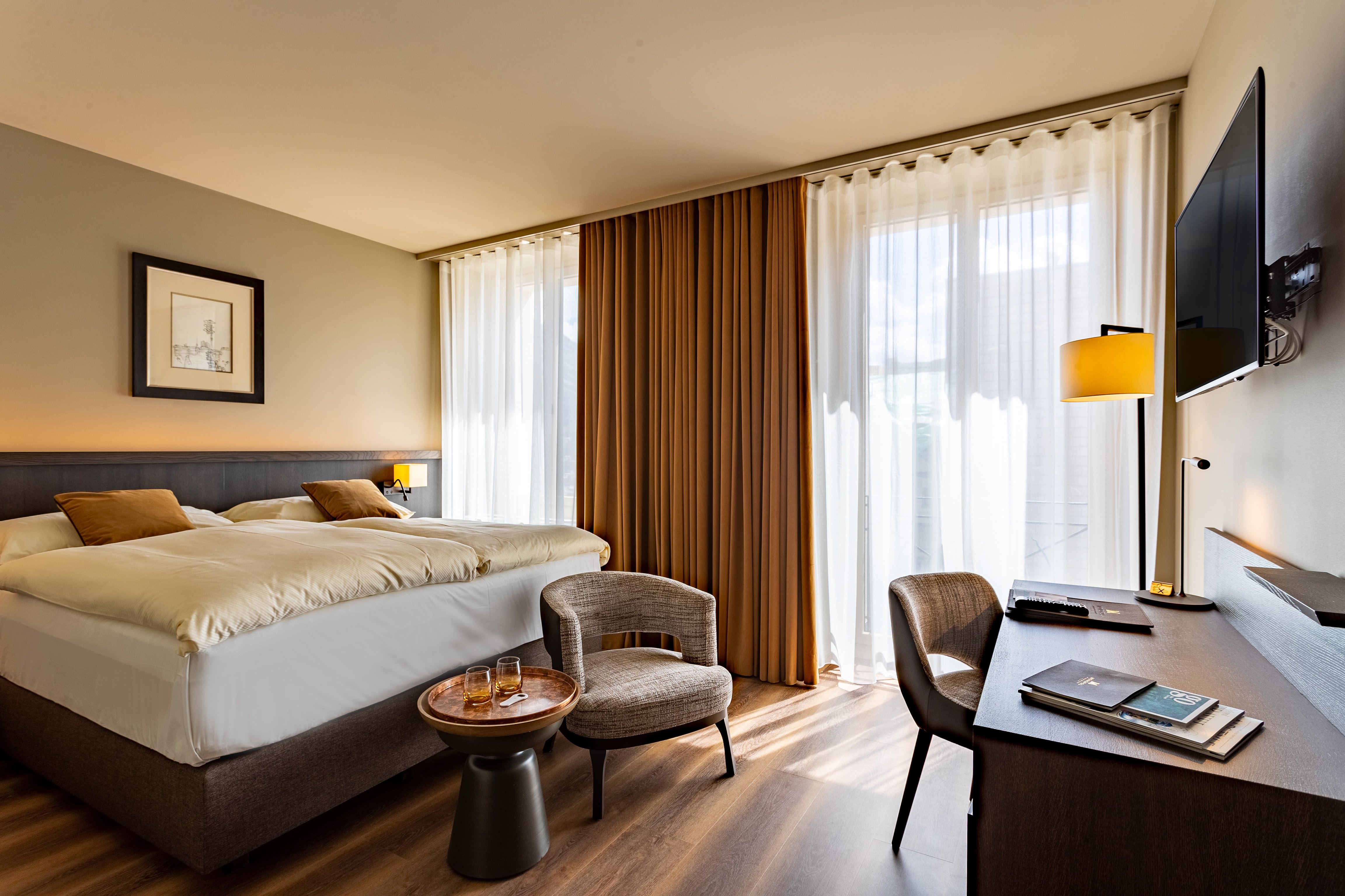 Guest room with an upholstered bed and warm wood accents at Art Boutique Hotel Monopol