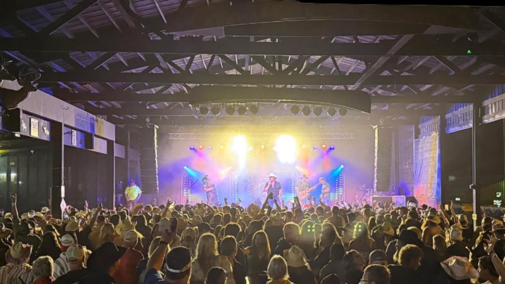 Packed crowd in cowboy hats at a Tailgate Revival show