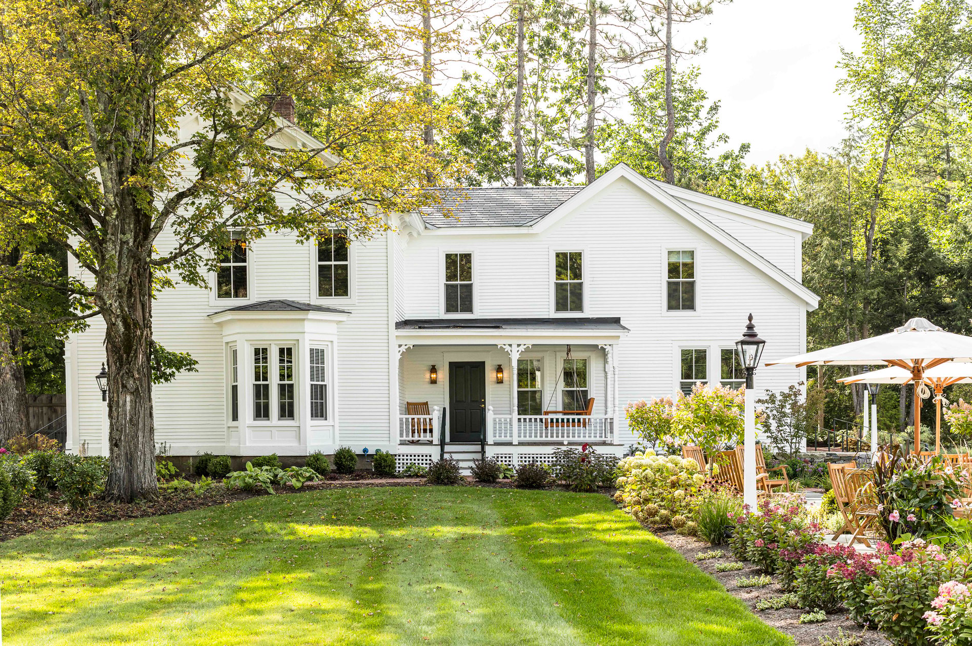 White farmhouse exterior and lawn at The Weston in Vermont