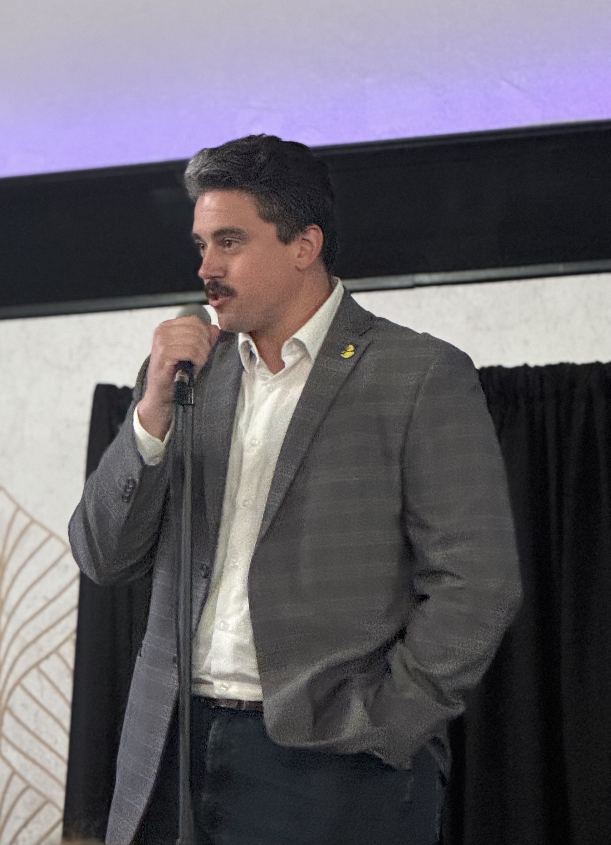 Joe Maddock speaking during the Cheers to Change celebration