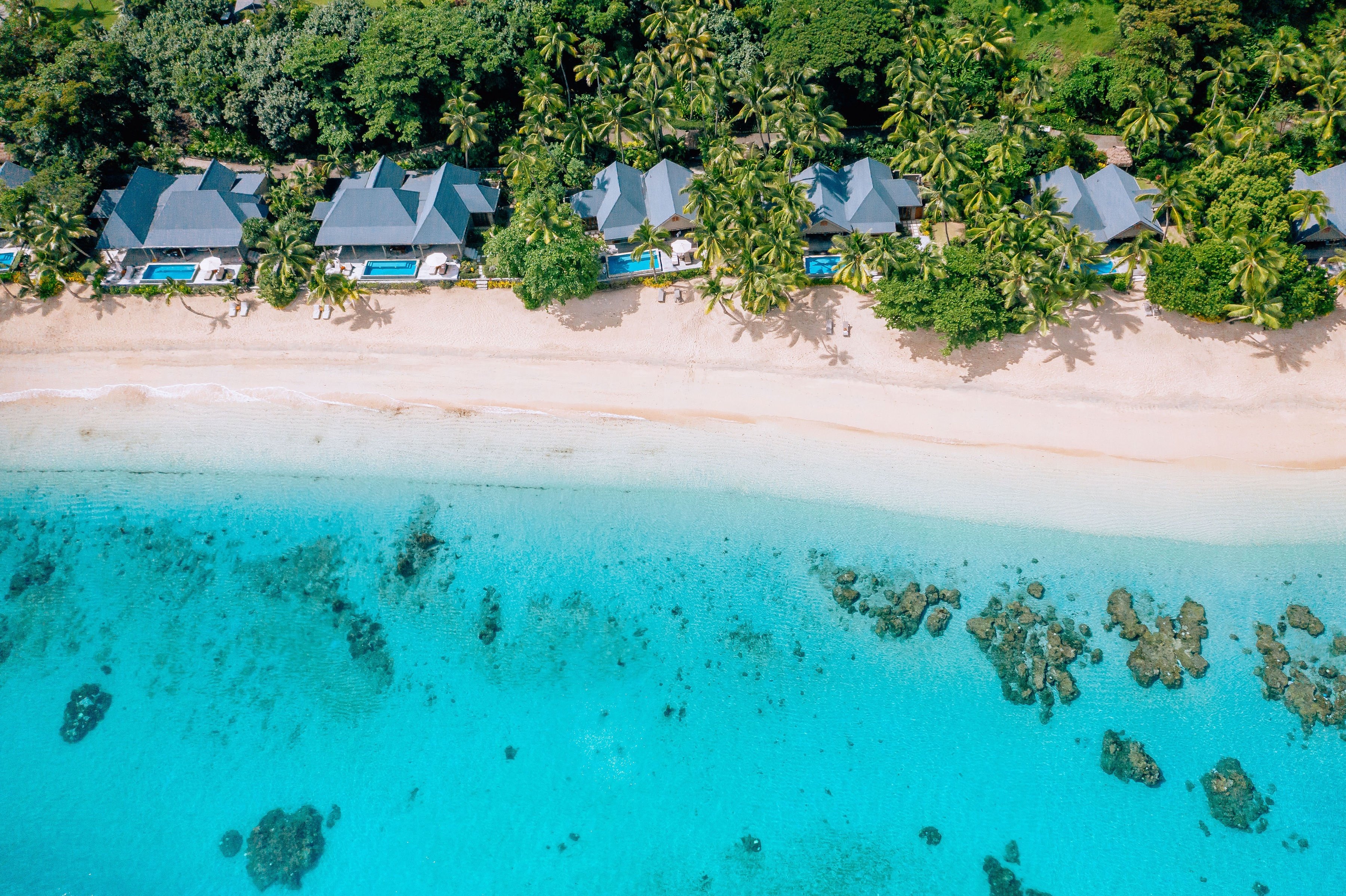 Beachfront villas and turquoise water at Kokomo Private Island