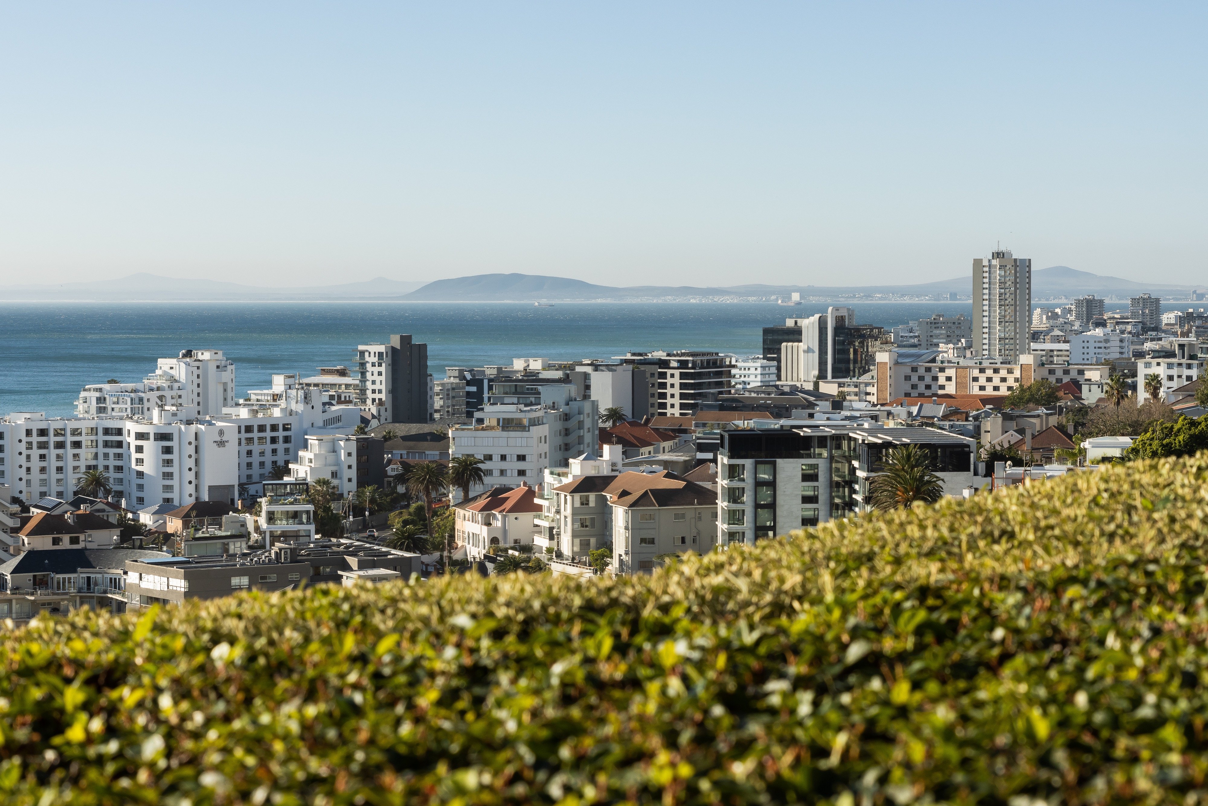 Cape Town and the Atlantic Ocean viewed across Ellerman House greenery