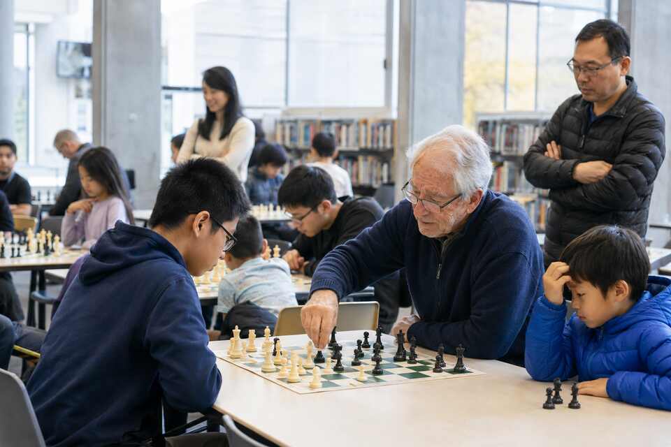 Children and adults playing casual chess together at Brighouse Library in Richmond BC