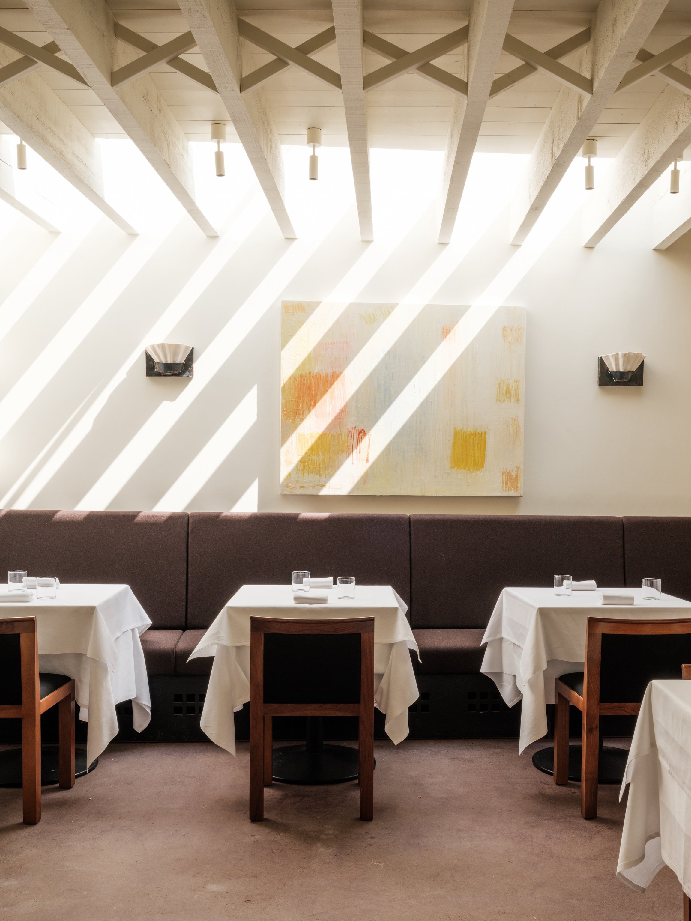 Light-filled dining room and exposed beams at Osip