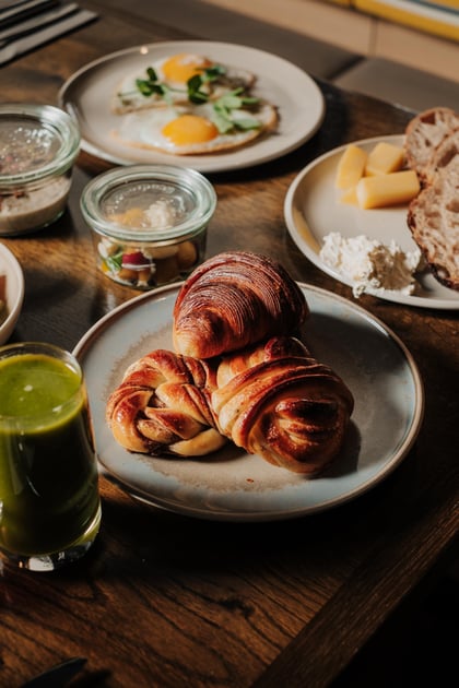 Breakfast spread with croissants and plated dishes at Villa Copenhagen