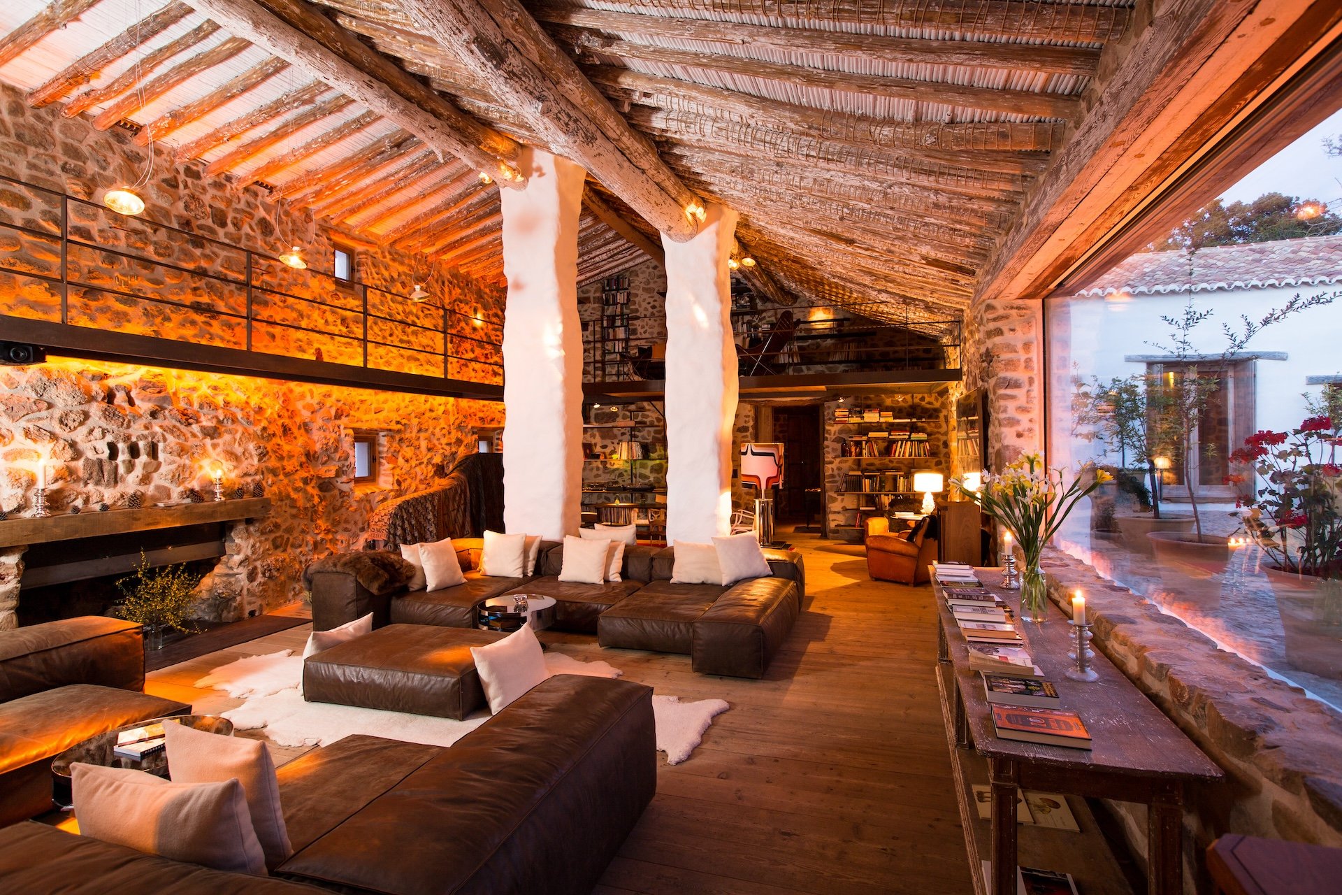 Rustic lounge and fireplace at Finca La Donaira